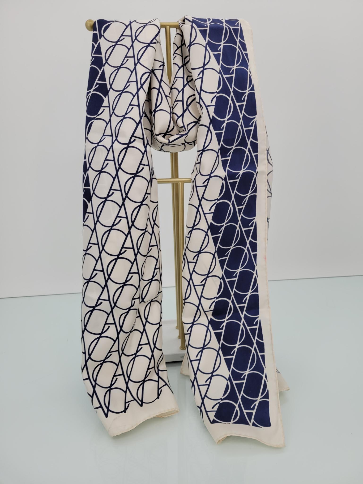 Vintage Van Cleef & Arpels Silk Logo Print Scarf: Description: Vintage Van Cleef & Arpels blue and white logo print silk scarf. Rolled edges. Some pink staining (see photos)Measurements: 60" x 15"