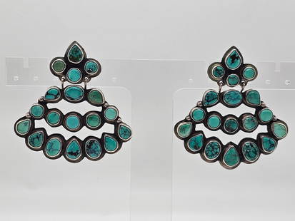 Oscar Betz Patasi Navajo Silver Turquoise Earrings: The earrings are marked by the Navajo Native American artist "Oscar Betz Patasi" and features a grouping of polished turquoise stones inset into sterling silver. Measures 2.25"W x 2.5"TWeight: 33.4 gr