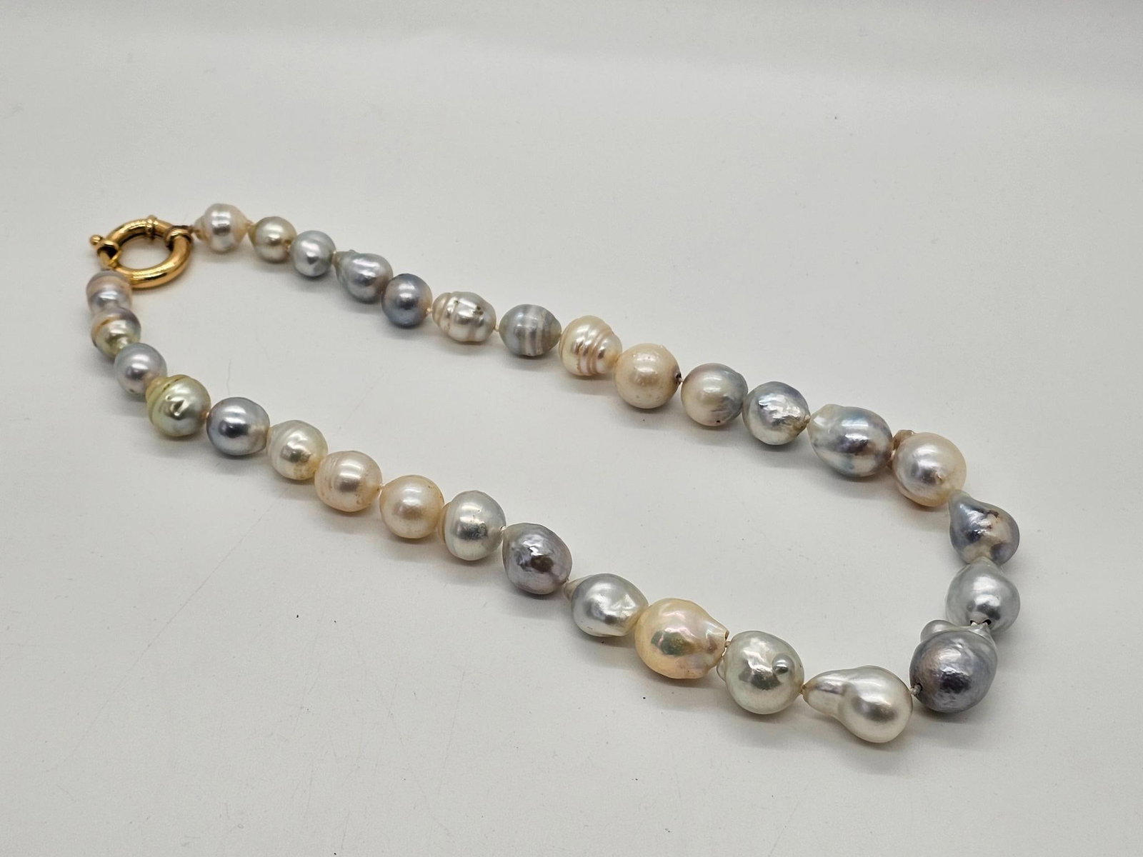 18" Single Strand Baroque Pearl Necklace: This necklace is large at 18" total length and appears to be Baroque pearls and a 14K yellow gold clasp. These appear of good quality, and vintage in age.
