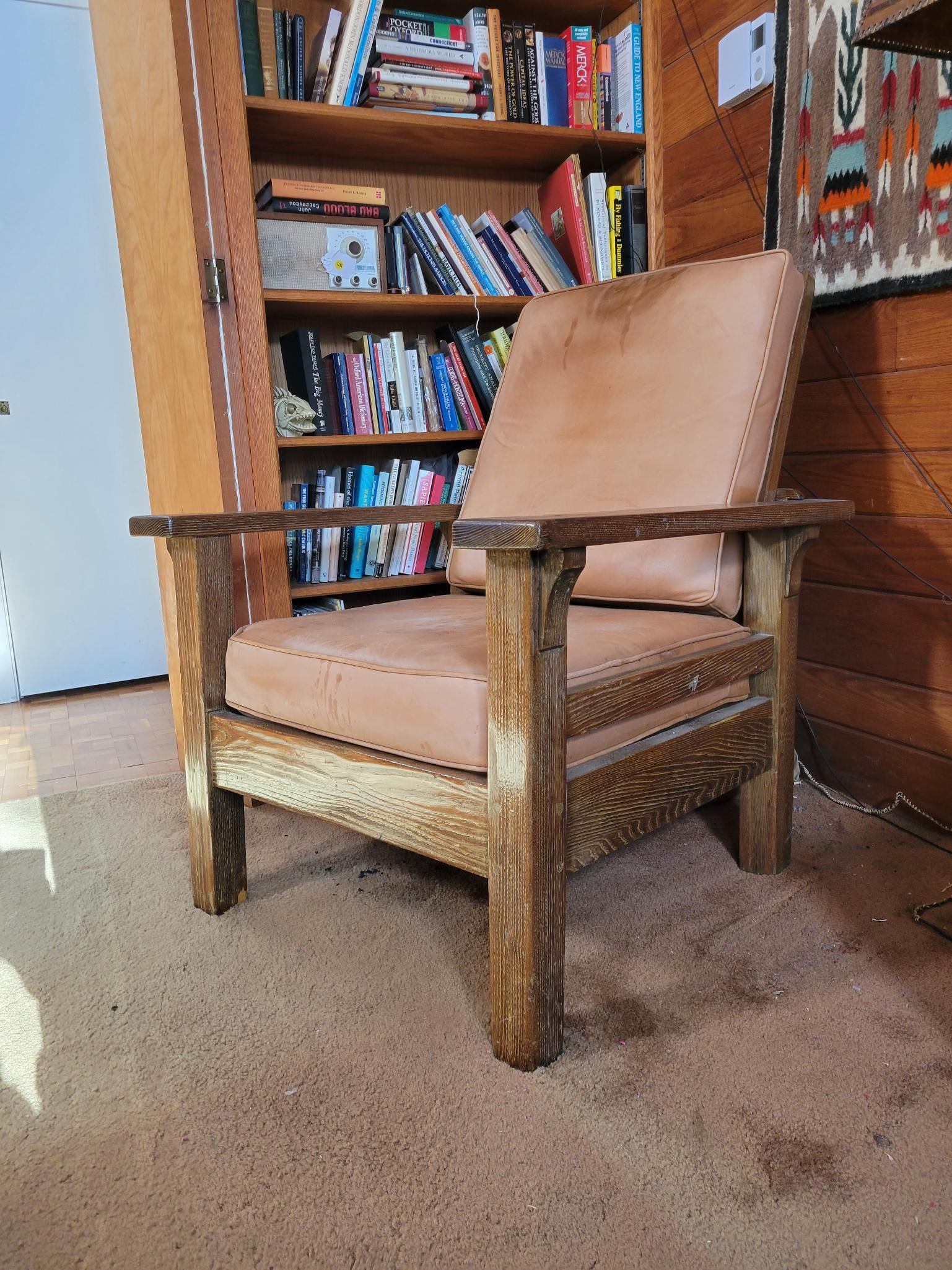 Antique Mission Oak Lounge Chair: Chair is unmarked, early 20th century in age with faded leather cushions. Back Adjusts with wooden post behind the back. Measurements: 37"L x 31"W x 38"H Transport Fee $50