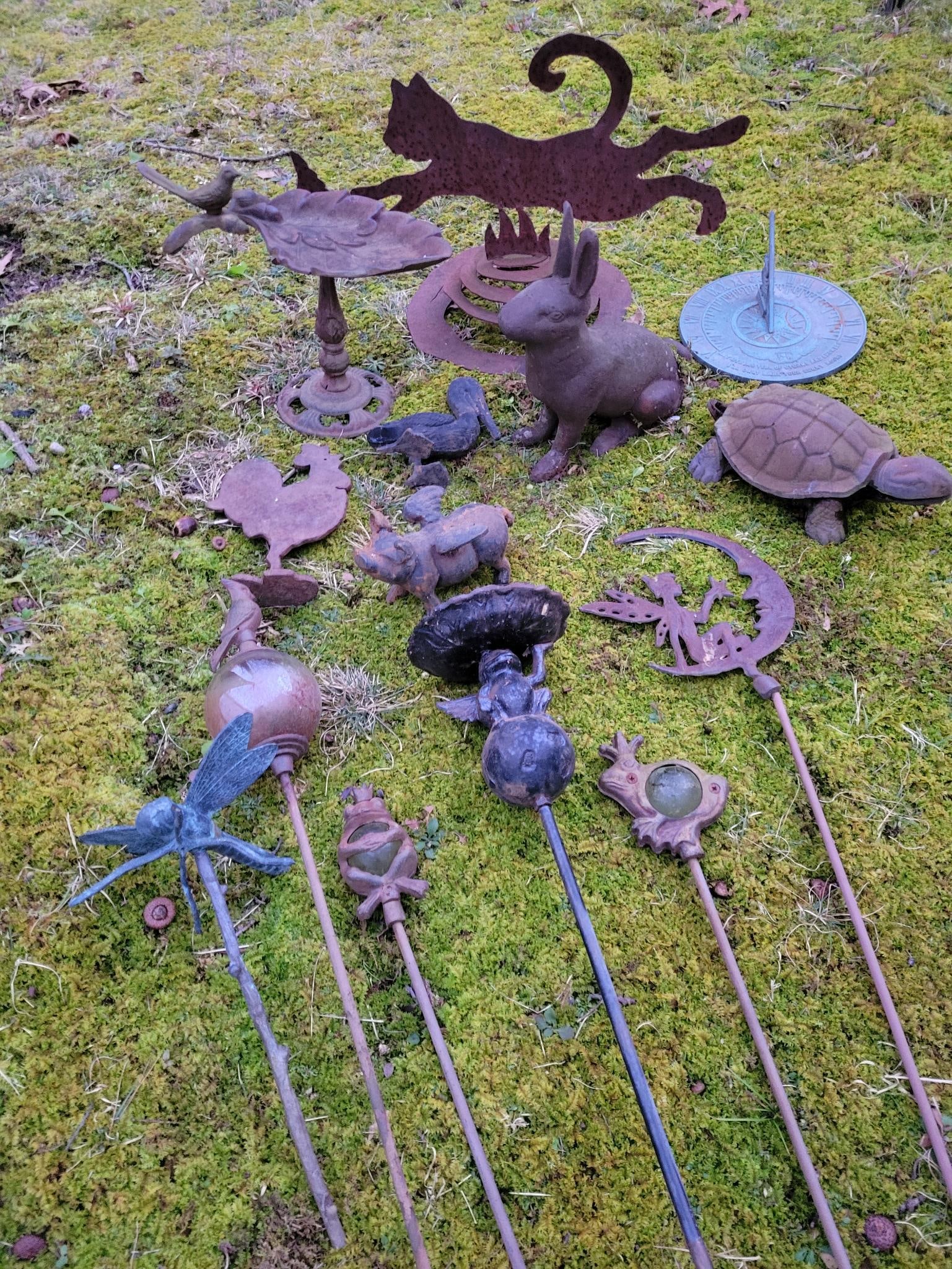 Outdoor Cast Iron Decor Lot: This lot includes a grouping of outdoor decor and decorative objects which are mostly cast iron. See photos for lot contents and conditions. Transport Fee $60