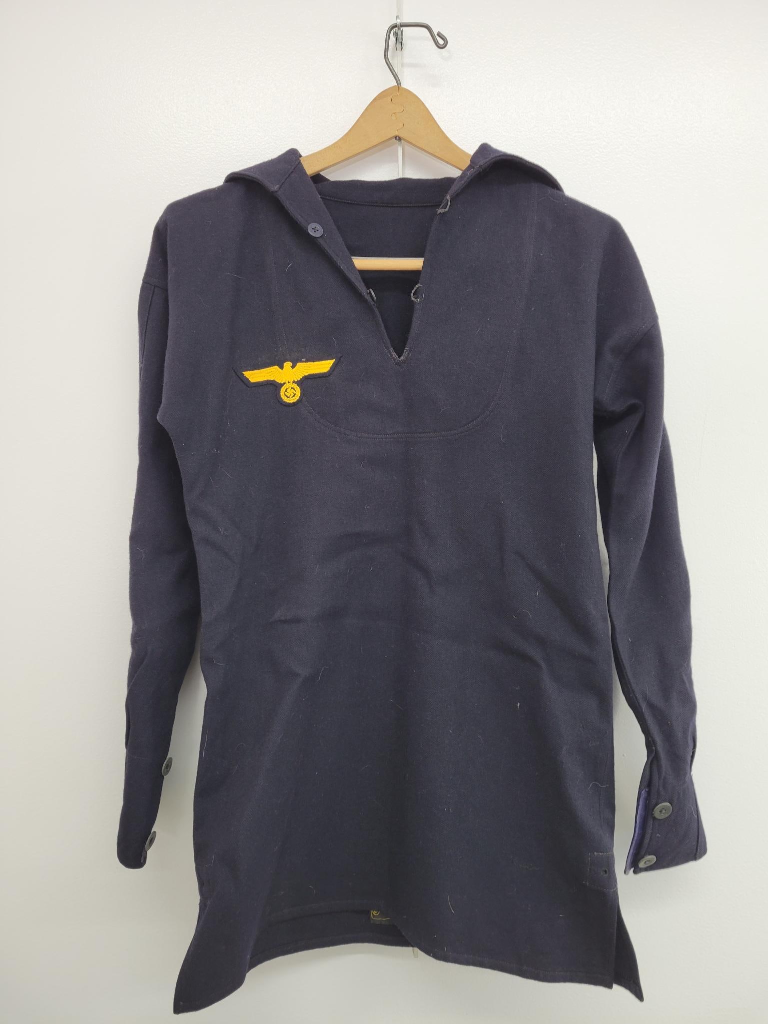 WWII German Kriegsmarine Sailor Jumper: The lot includes a period original WWII Nazi German Sailer Jumper with collar. The jumper is in good original condition with minimal ware from age and use. Made by "Arthur Kuck, Berlin" as marked on t