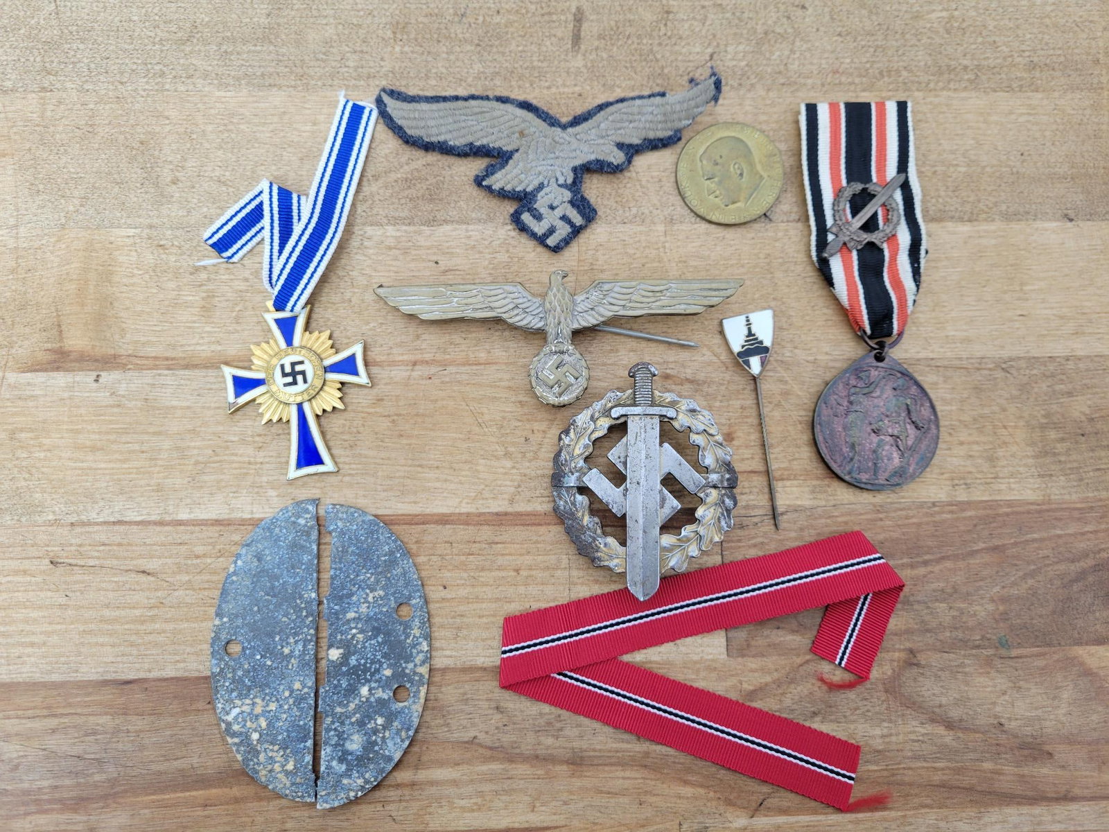 Estate Lot of WWII German Pins & Insignia: This lot includes a small grouping of WWII Era Nazi Germany pins, insignia, and medals. See photos for lot details, contents, and conditions. All pieces appear to be 100% genuine from a avid military 