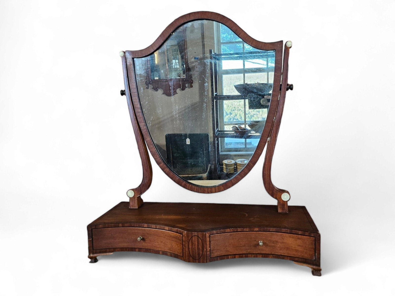 Federal Mahogany Shield Dressing Swing Mirror: Federal style mirror retains it's original finish with inset bone buttons around the mirror. Features 2 drawers with brass pulls, mirror glass appears to be original. 19th century in age, overall in g