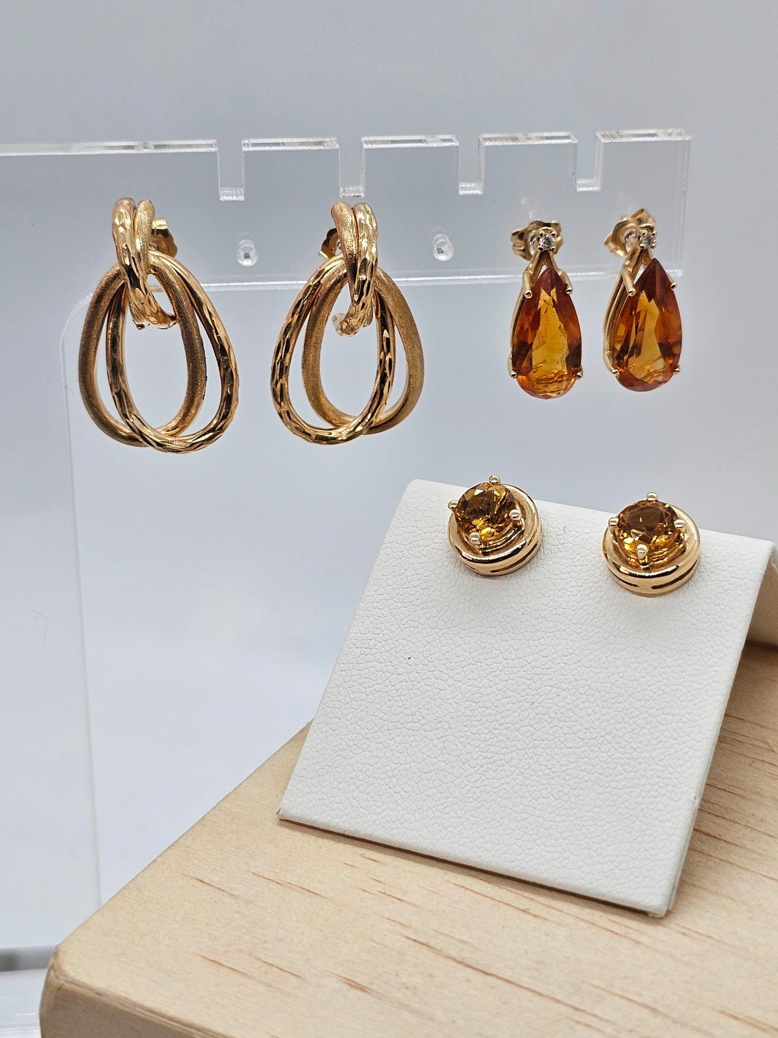3 pc Lot of 14K Yellow Gold & Gemstone Earrings: This lot includes 3 pairs of 14k yellow gold earrings, two of which are set with amber colored gemstones. Total lot weight is 5.4 dwt