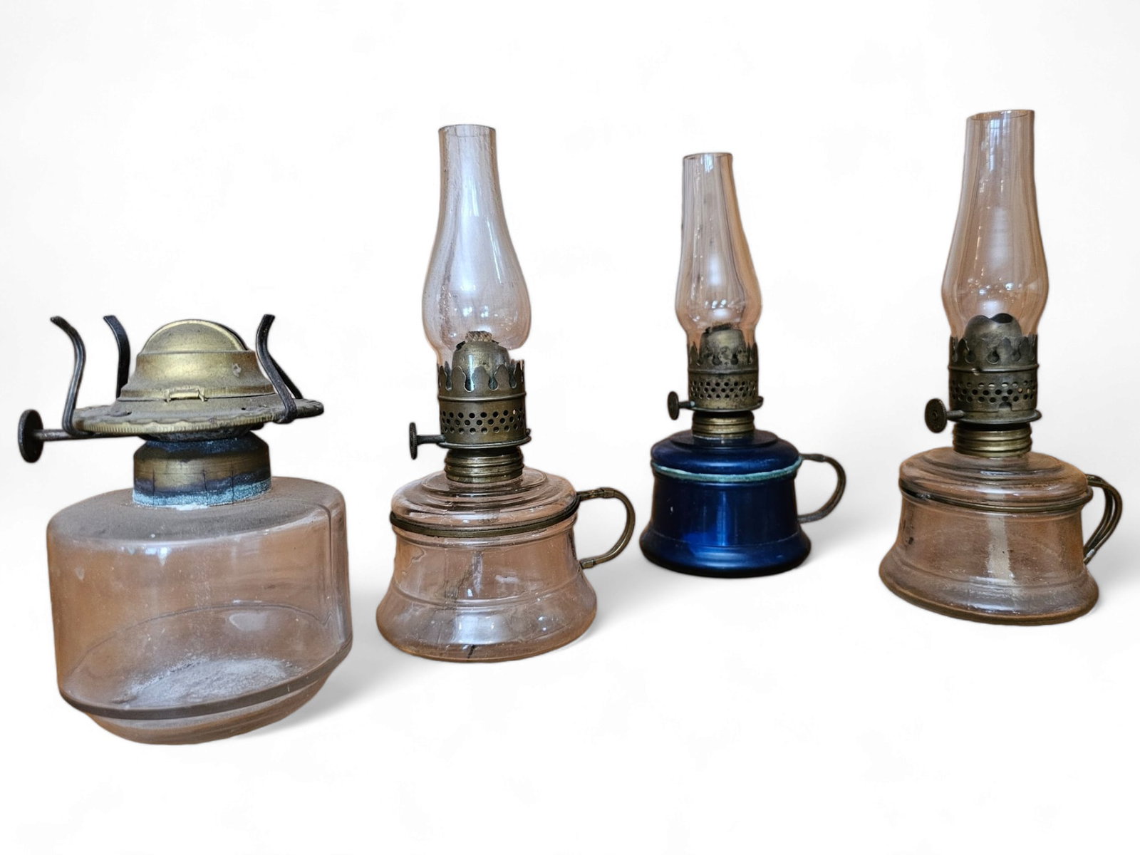 Grouping of 4 Antique Miniature Finger Oil Lamps: The lot includes the 4 miniature oil lamps seen in the photos, one is missing the chimney. They are all in good antique condition without any notable damage beyond ware from age and use. Measurements:
