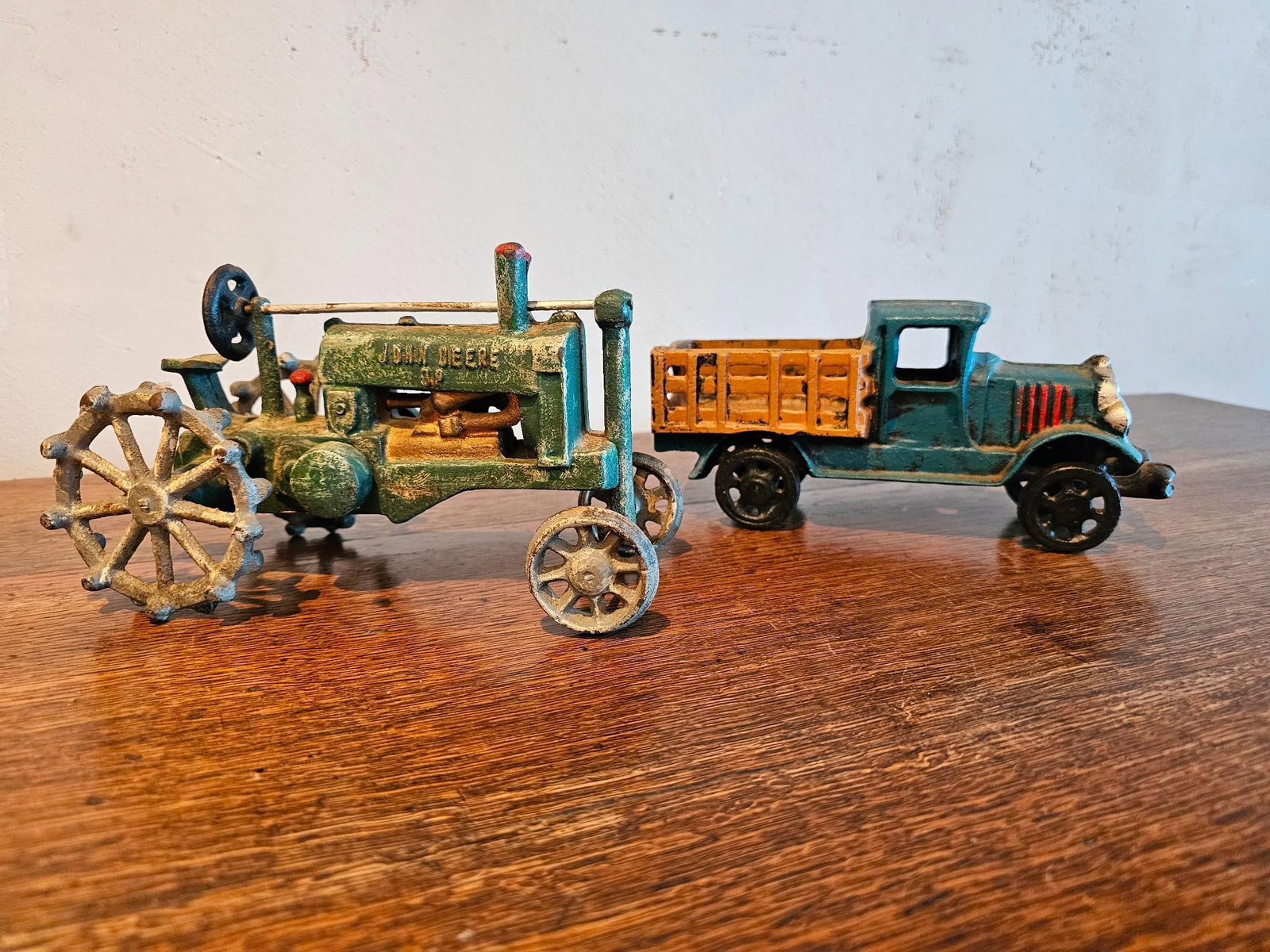 Pair of Cast Iron Toys: This lot includes a pair of cast iron toys, these are reproductions. Condition is very good with minimal ware from age and use. Measurements: Tractor is 8"L x 4.25"W x 5"T ; Truck is 8"L Fee for Trans