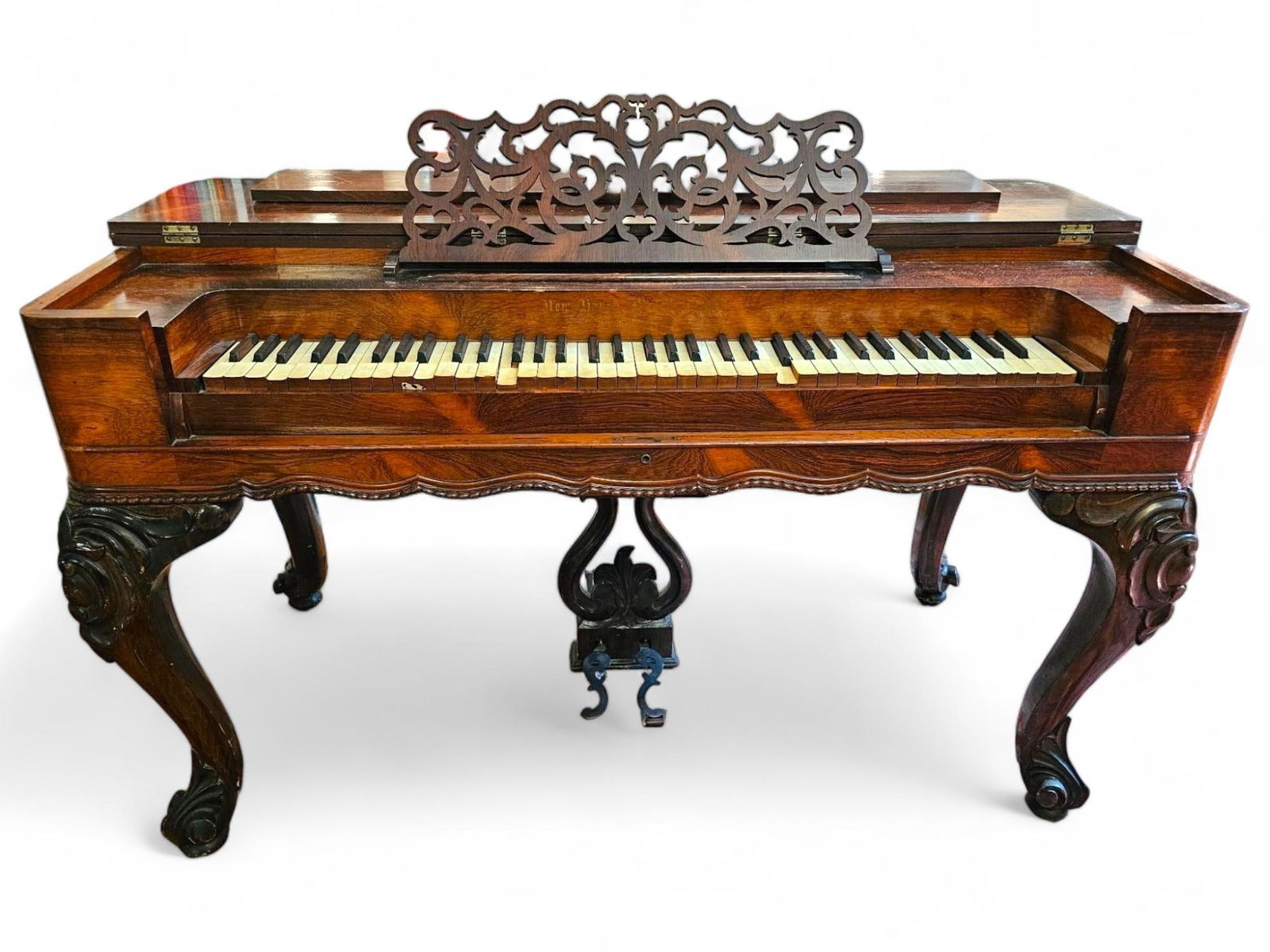 19th C. Victorian Rosewood Organ: The organ is in beautiful antique condition with carved rosewood legs and fretwork music stand. The organ though appearing in good condition, needs the pedal reattached, it appears to be missing the r