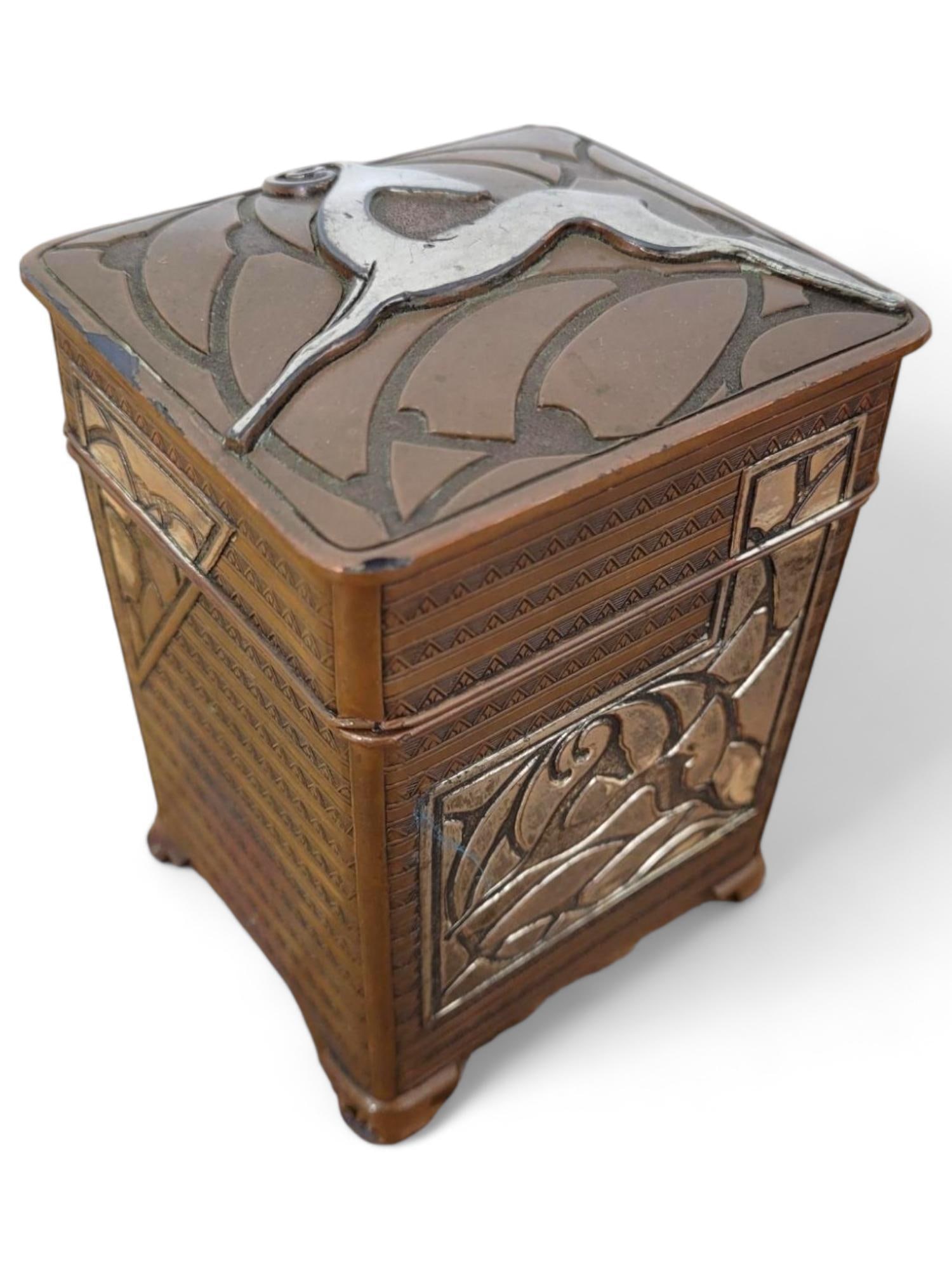 Arts and Crafts Bronze & Silver Covered Box: An Arts and Crafts style bronze box, adorned with a relief design of a deer and intricate patterns. The box is in overall good vintage condition with expected ware from age and use. Measurements: 3"L 