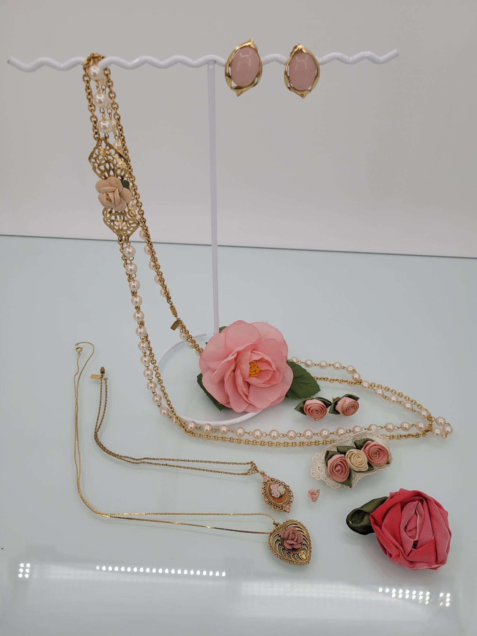 Rose Garden Party Jewelry Lot: Description: This adorable collection of rose themed jewelry comes with three necklaces (one is missing part of a clasp as seen in photos) three fabric pins and two pairs of earrings