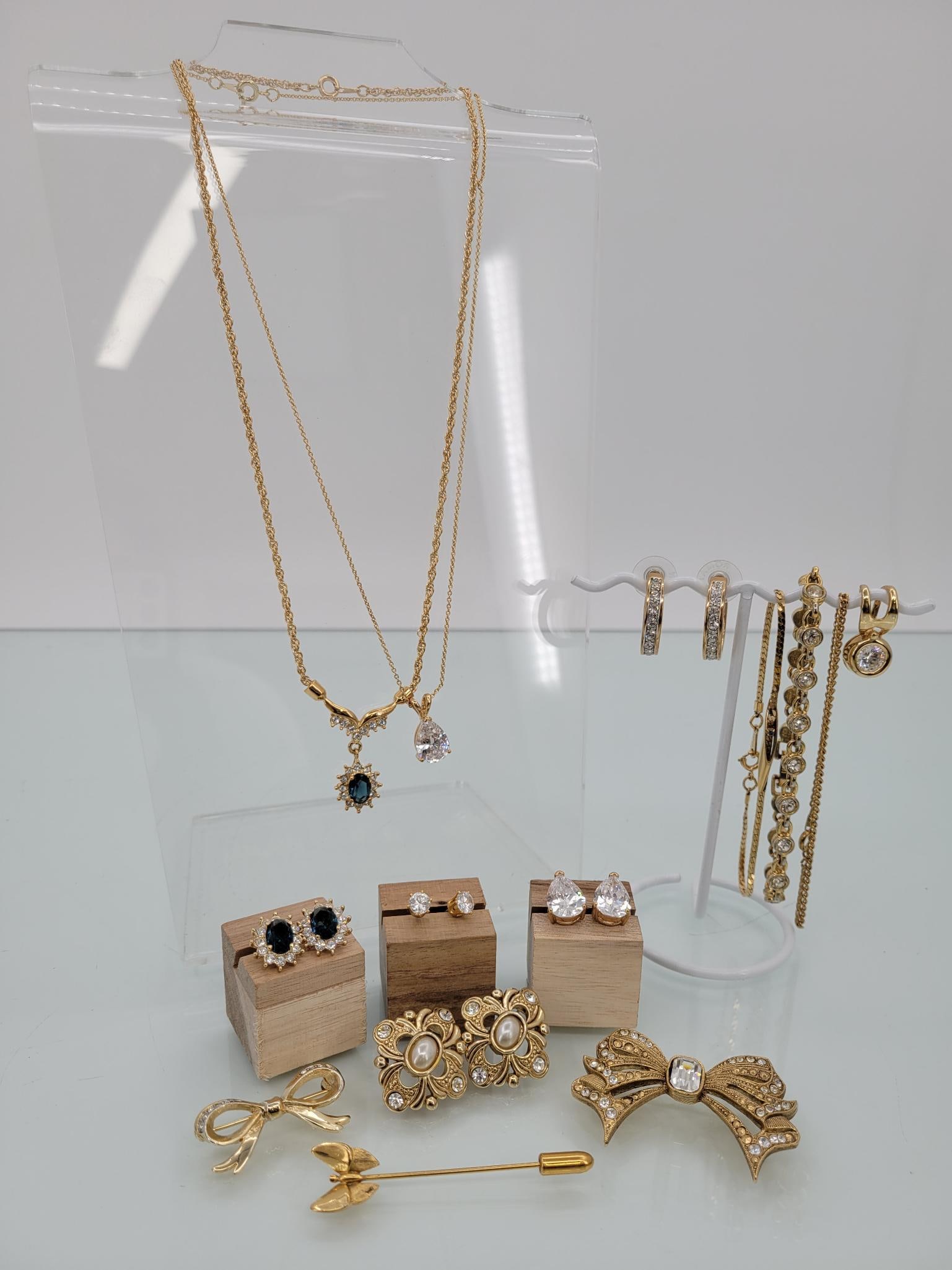 Gold Tone Glamor Lot: Description: This dazzling lot comes with two necklaces (with two swapable pendants) 5 pairs of matching stud earrings, three pins and three bracelets
