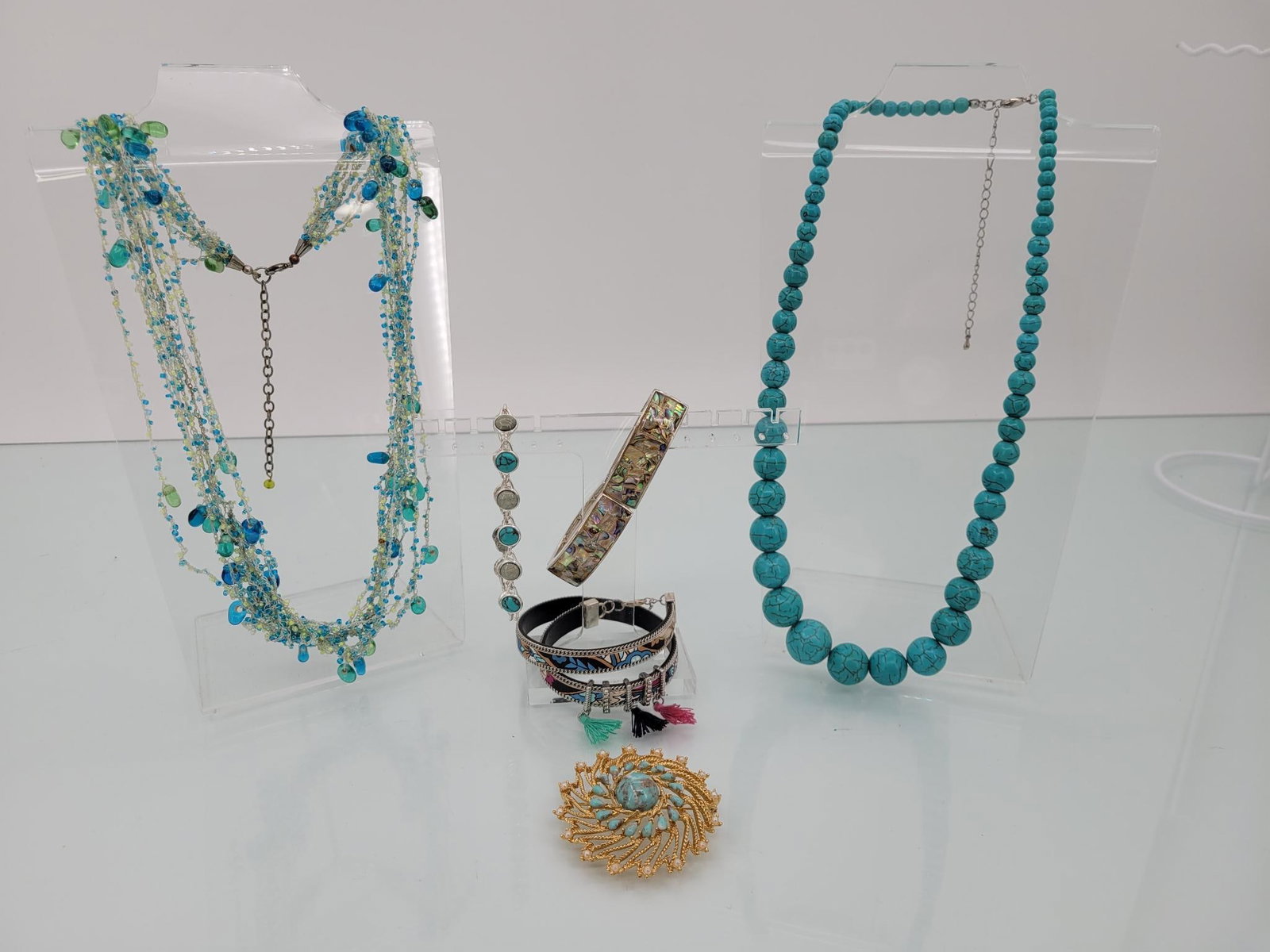 Sky Blue Jewelry Lot: Description: lot includes two necklaces, three bracelets, and one large pin