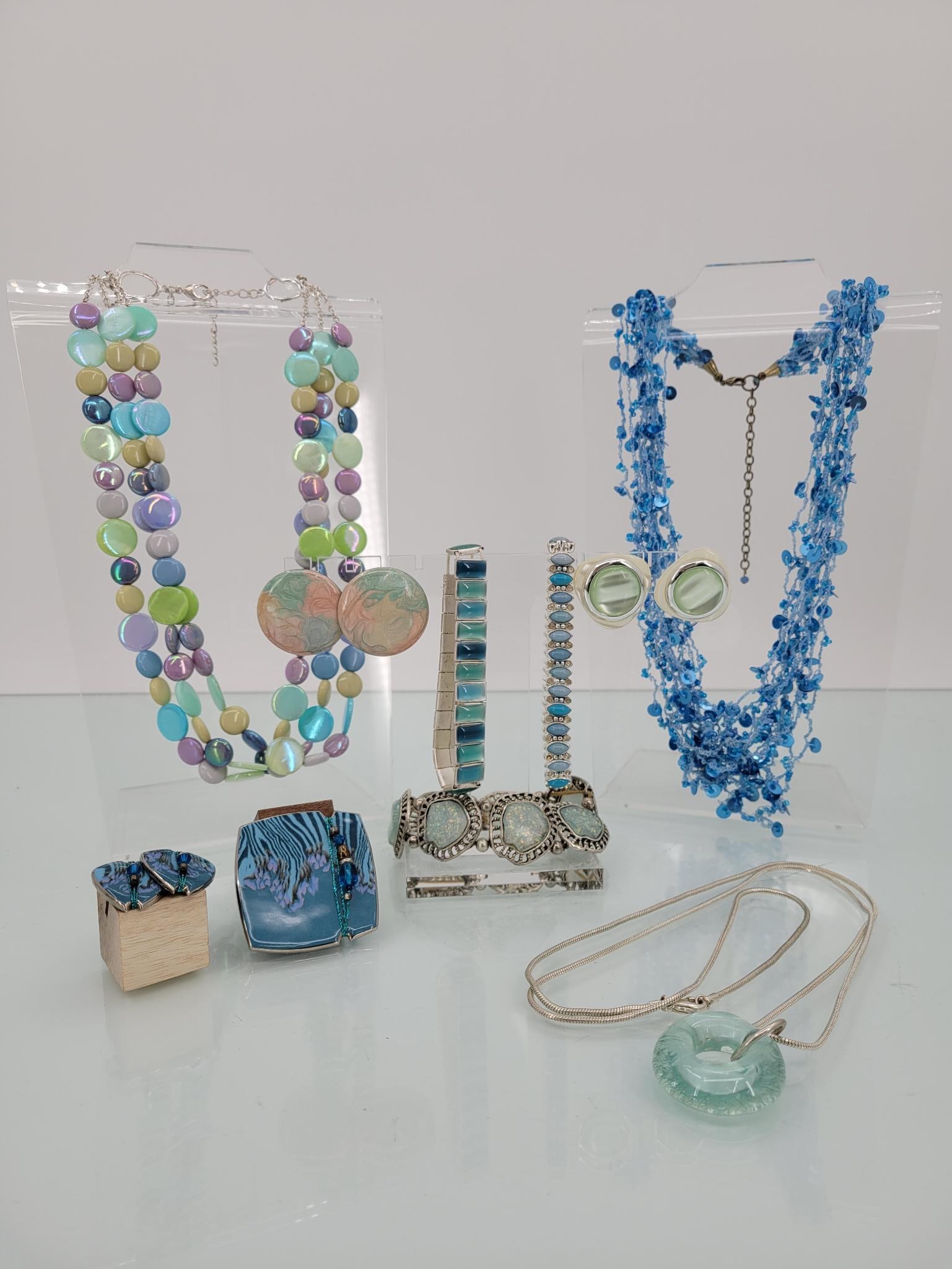 Blue And Pastel Party Jewelry: Description: Includes three necklaces, three pairs of post earrings, three necklaces and a pin