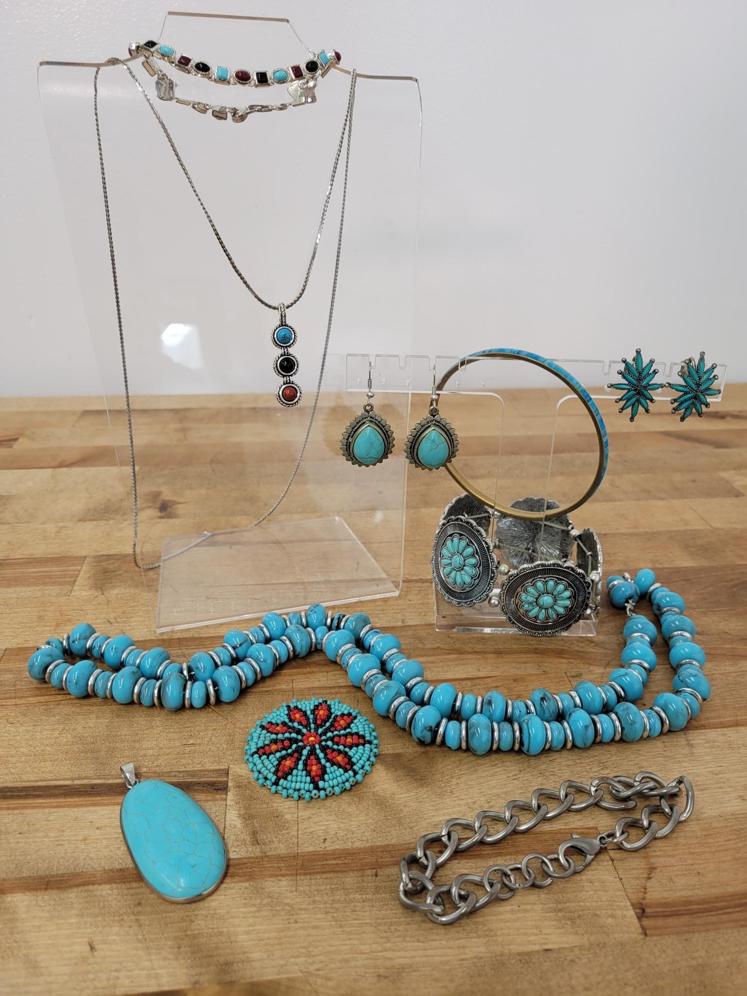 Southwestern Boho Costume Jewelry: Description: lot includes two necklaces, four bracelets, a pendent, beaded piece which can be worn as a pin or a pendent, and two pairs of earrings. One pair are clip on and the other a hanging
