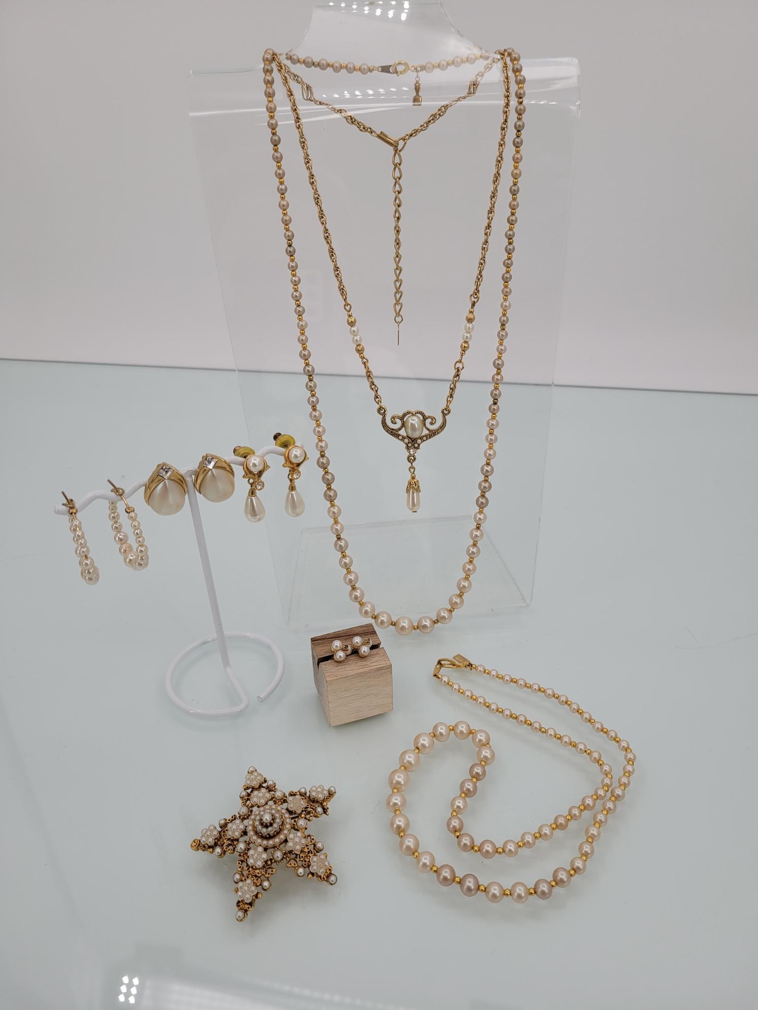 Champagne Toned Vintage Pearl Costume Jewelry: Description: lot includes two strings of champagne toned costume pearls, a gold toned necklace, four pairs of earrings ( two posts, on clip and one hoops) and a large star pin (pin is missing one smal