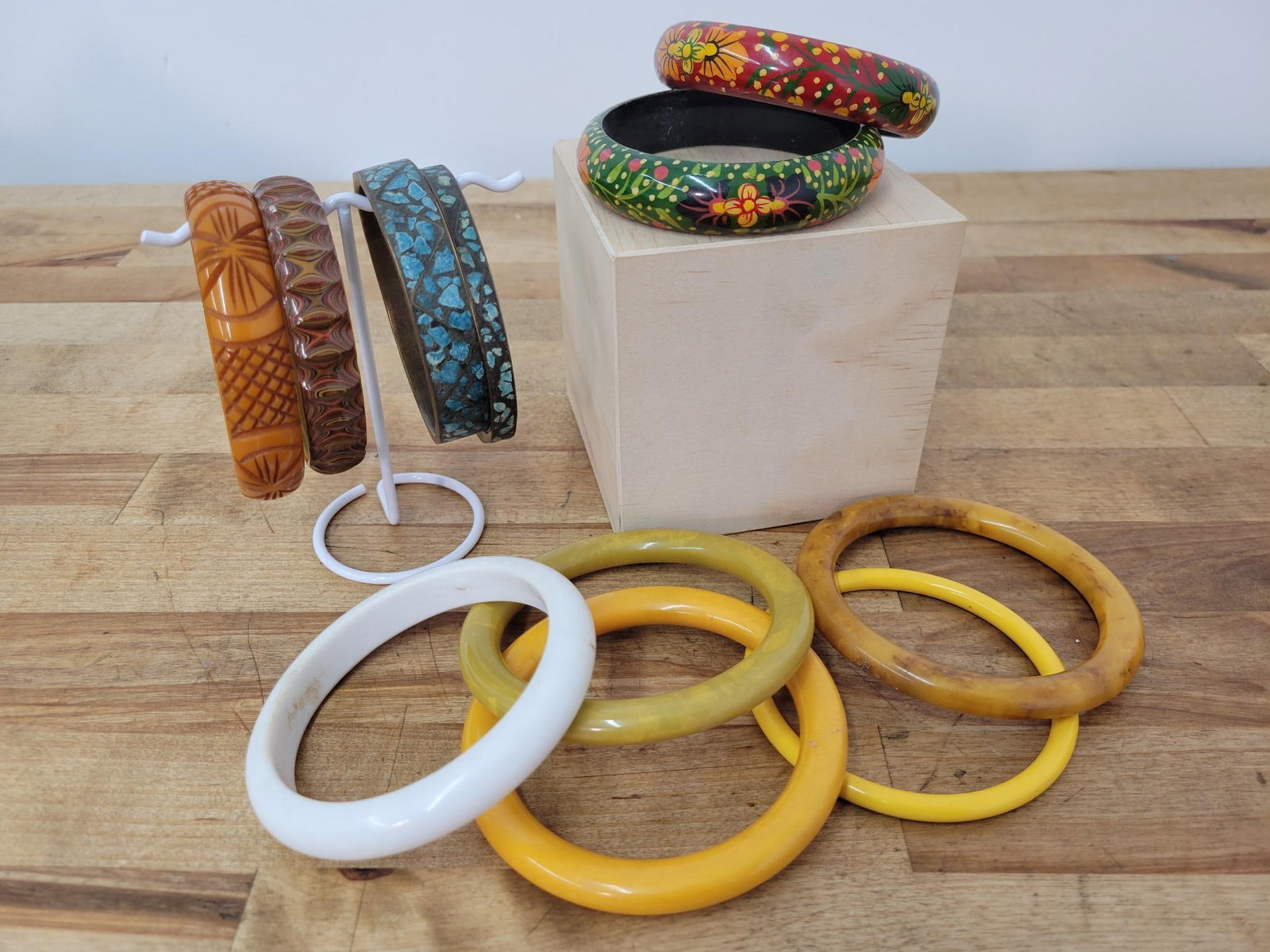 Mixed Material Vintage Bangles: Description: Lot includes seven acrylic bangles (one has a crack, see photos) hand painted wood bangles, and two brass and stone bangles for a total of eleven