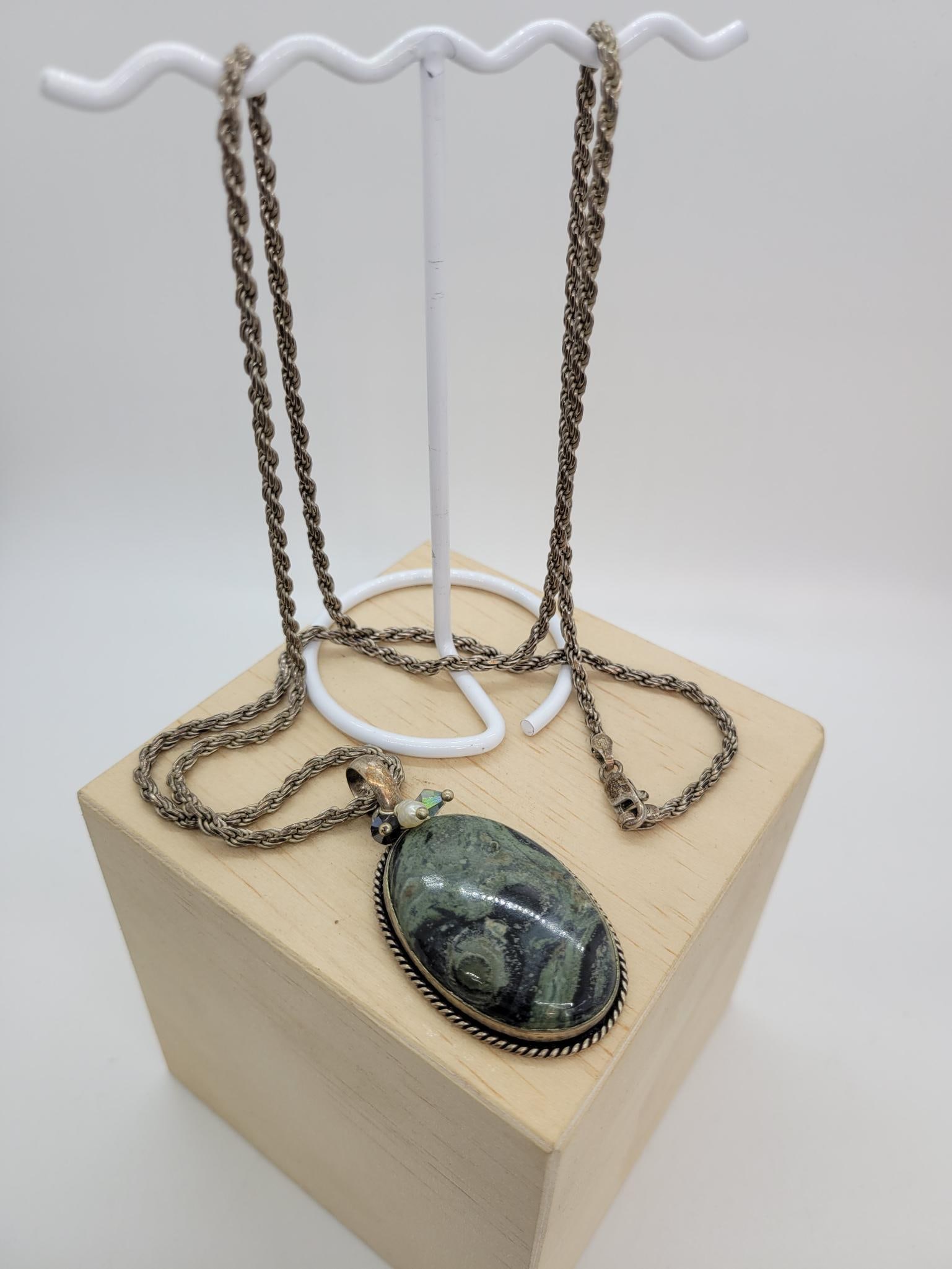 Vintage Jasper Stone In Silver On A Silver Chain: Description: Large vintage jasper stone set in sterling silver (topped with two crystals and a freshwater pearl) on a long silver chain. Pendent weighs 13.2g, chain 21g with a combined weight of 34.1g