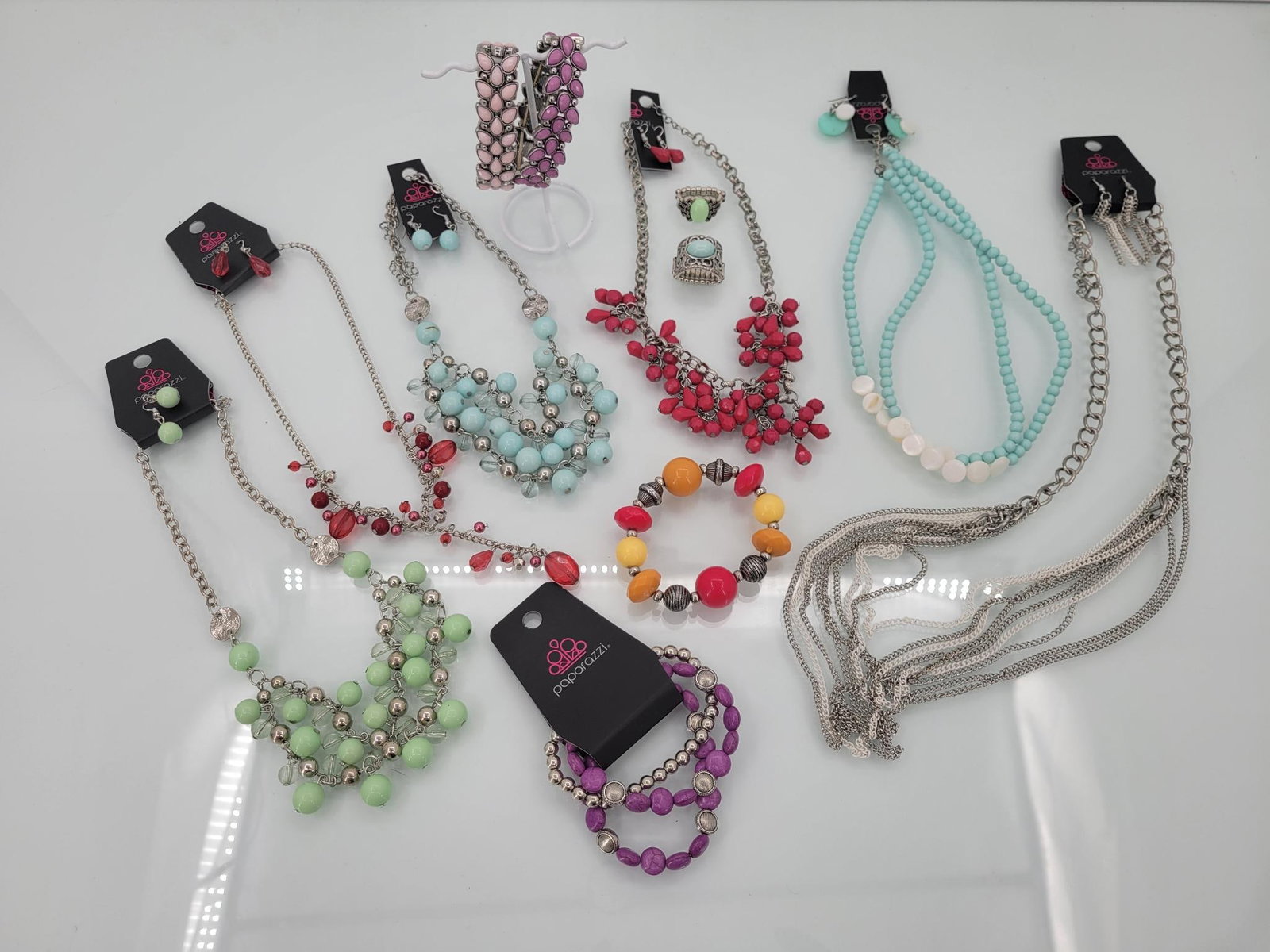 Paparazzi Mega Jewelry Lot: Description: lot is bursting with six new with tags matching necklace and earring sets, four elastic bracelets and two elastic rings