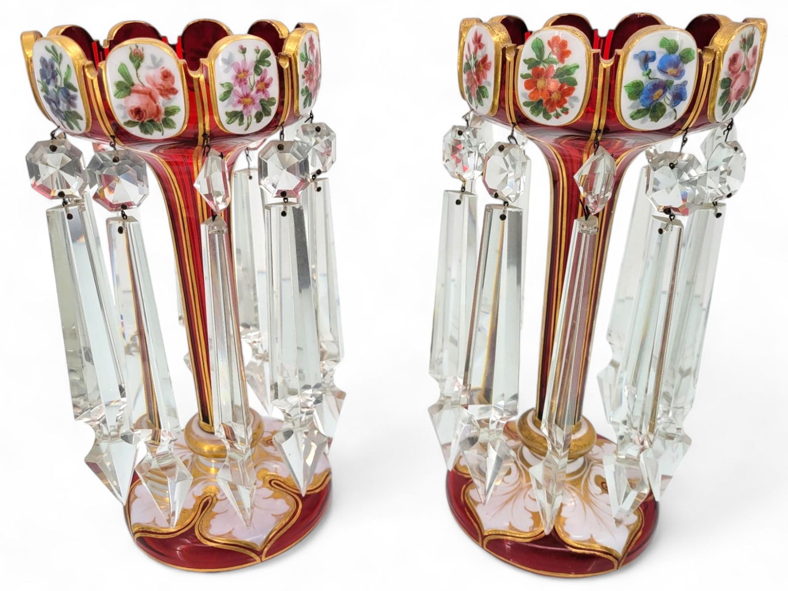 Pair of Red Glass Mantle Lusters by Moser: Pair of red glass mantle lusters with hand-painted floral decorations and hanging crystals. Both lusters are in good condition with minor surface wear and fading consistent with age. There does not ap