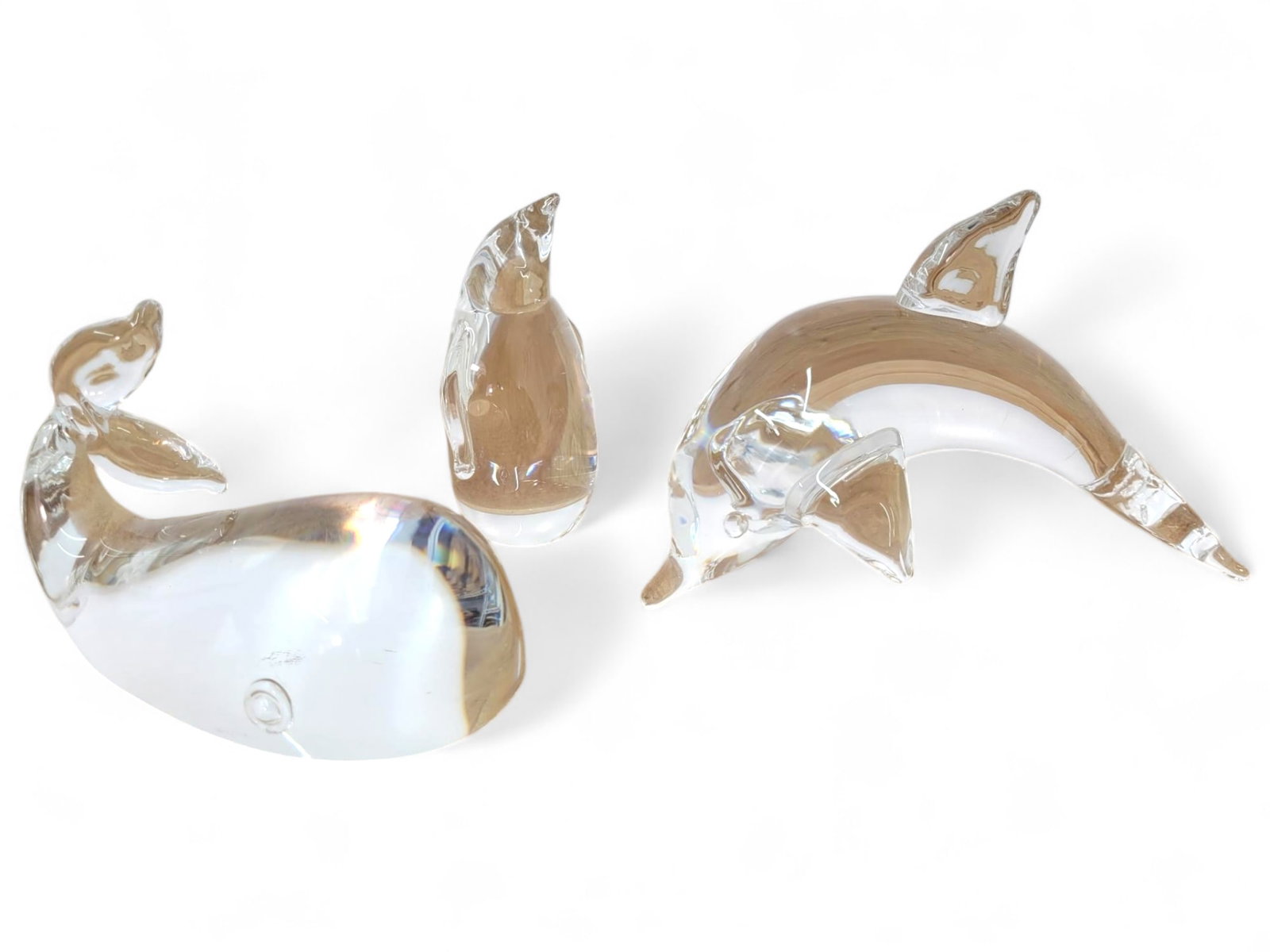 Steuben Crystal Dolphin Seal & Penguin Figurines: Set of three Steuben crystal figurines: dolphin, seal, and penguin. All are in good used condition with no chips or cracks. Minor surface wear may be present. Measurments: Whale is 5"L x 2.5"W x 3"T