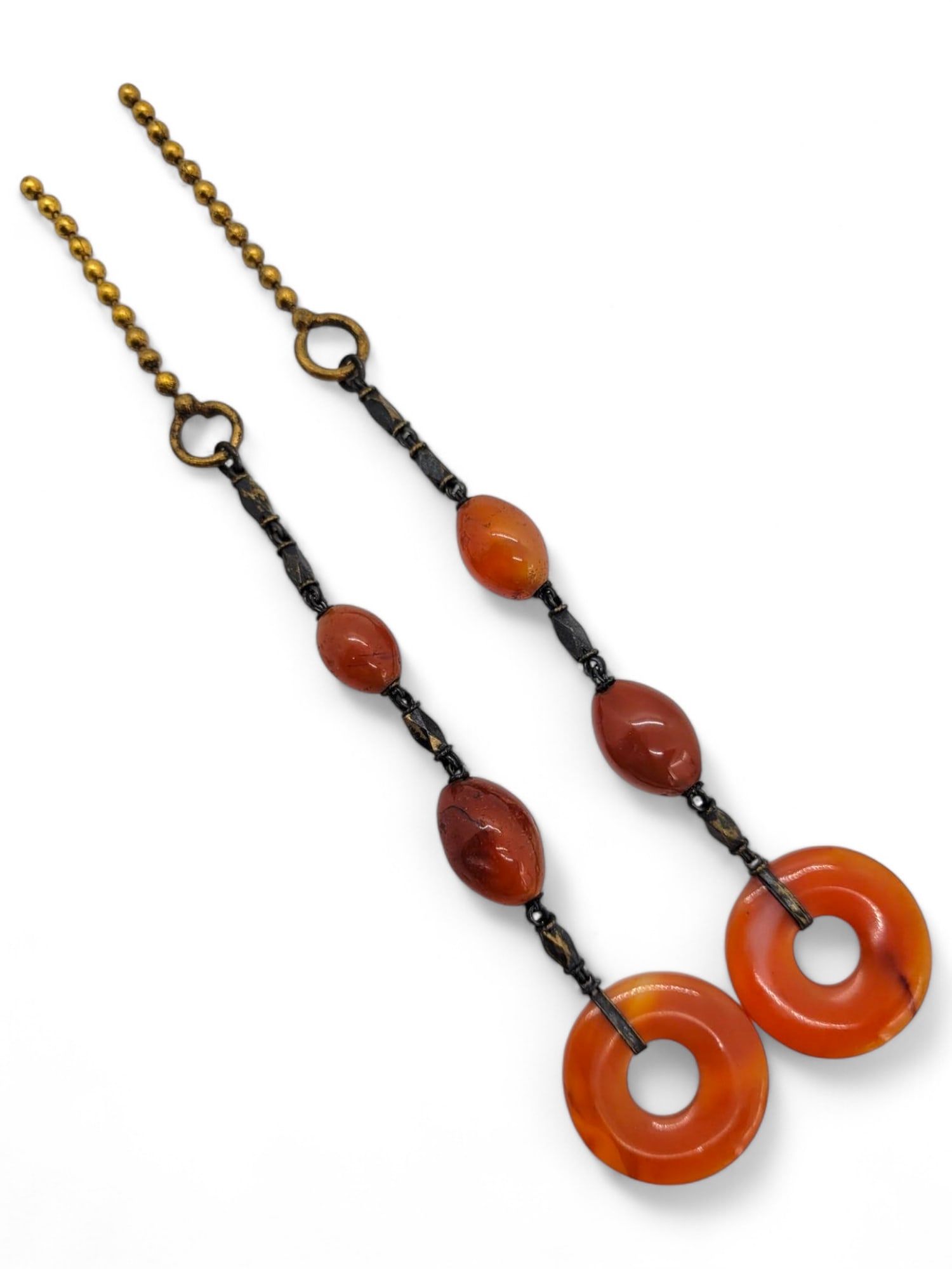 Pair of Chinese Carnelian Bead Pendants: This lot includes a pair of Chinese pendants featuring what appears to be carnelian beads, each connected by brass chains. The pendants include circular carnelian discs and oval beads, showcasing the 
