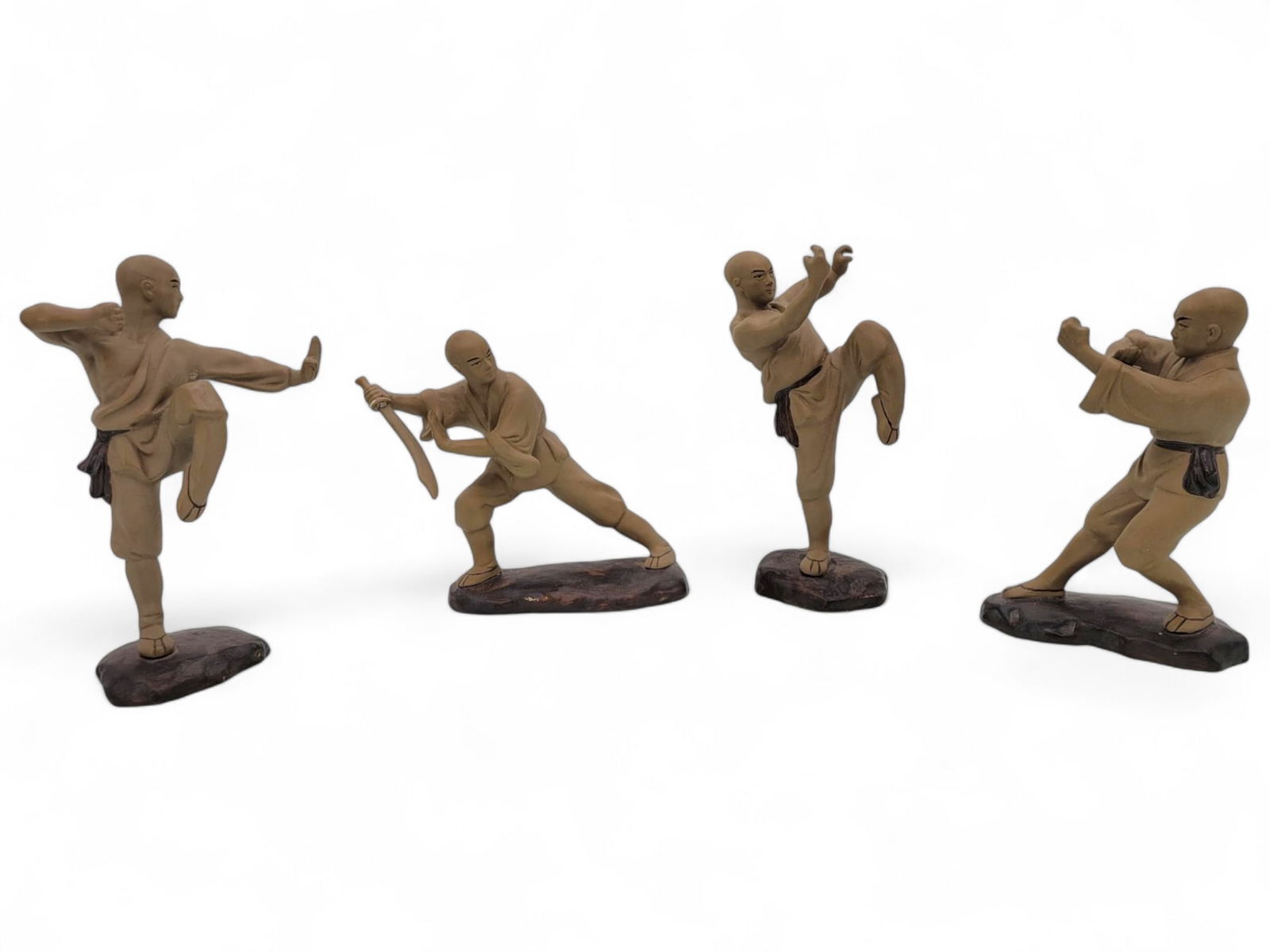 4pc Chinese Mudman Shaolin Martial Arts Figures: A set of four martial arts mudman figurines, each depicting a different action pose. The figures are crafted from a resin material with a natural, earthy finish. A sticker on the back of the figures r
