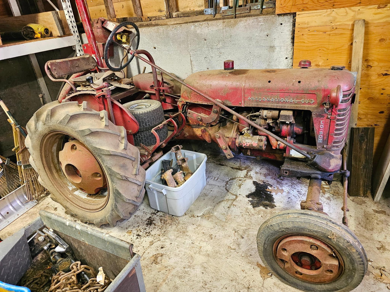 1956 International Cub Lo-Boy Tractor: The tractor is in barn found condition having been always stored indoors. Dates to 1956 by the serial number (3304) and overall is in fair condition with rust, ware, and losses from age and use. The l