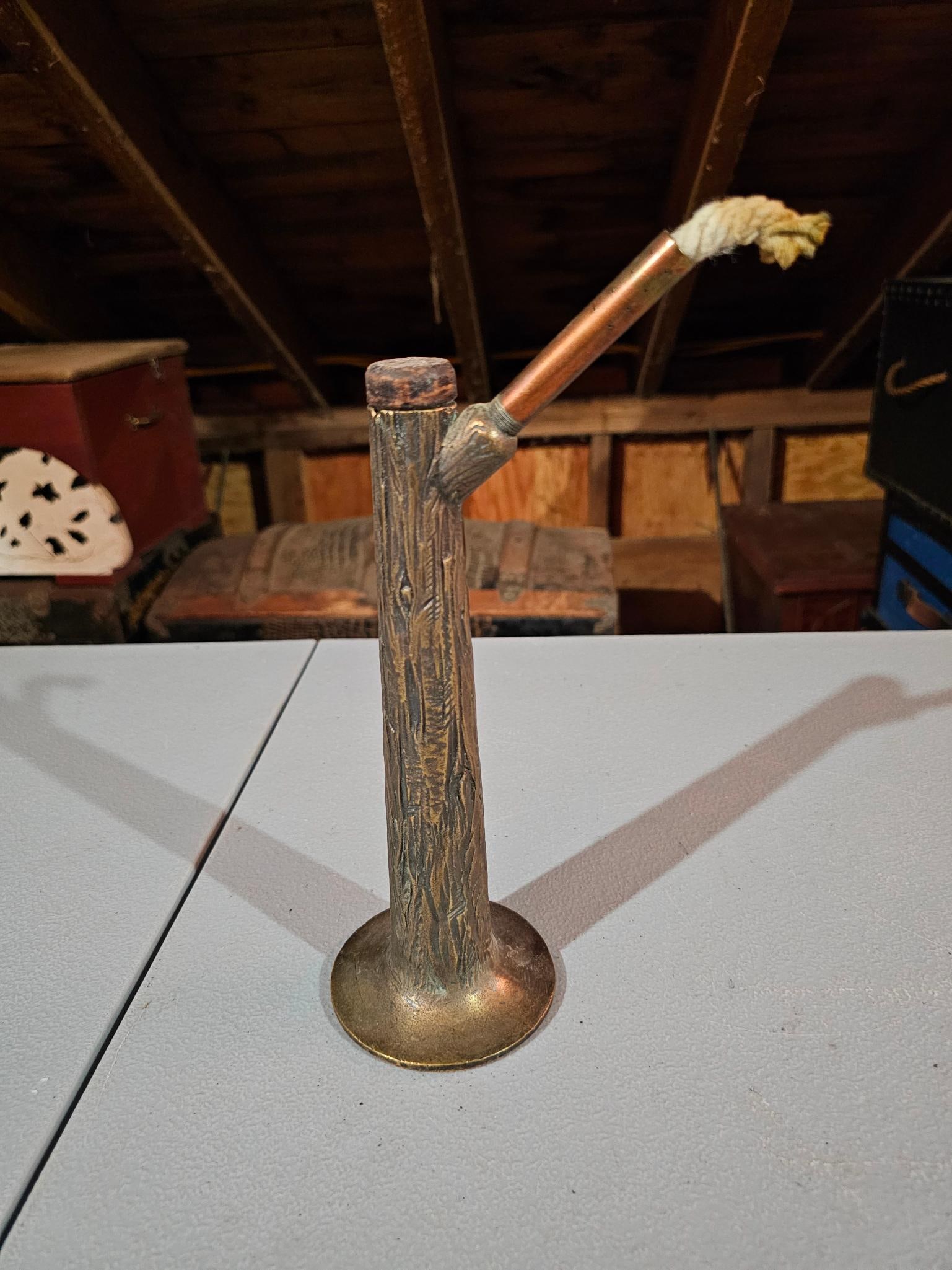 Brass Tree-Shaped Lamtern / Lighter: Brass lighter or lanter in the shape of a tree trunk, with a wick coming out of the side. Estate-found condition with surface wear. See photos for more details on condition. Measurements: 3.5"L x 4"W 