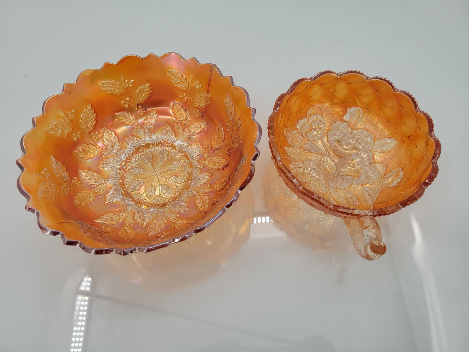 Pair Of Marigold Floral Bowls: Maker: Fenton, Imperial Pattern: Marigold holly berry bowl, marigold pansy and button handled bowl Condition Issues (If Any): luster loss in both bowls Holly berry bowl measurements: 7.5 "L x 3"H Cond