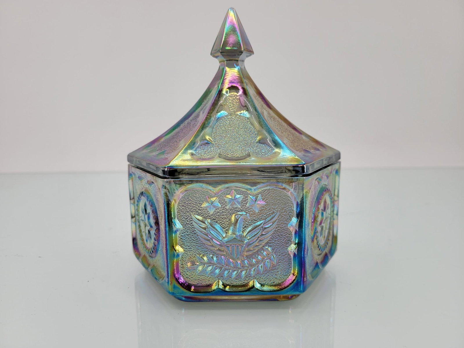 Indiana Iridescent Tiara Eagles & Stars Candy Dish: Maker: Indiana Pattern: Iridescent tiara eagles and stars candy dish with lid Condition Issues (If Any): none Measurements: 5 "L x 6" H Condition Buyers Premium: 28% For t