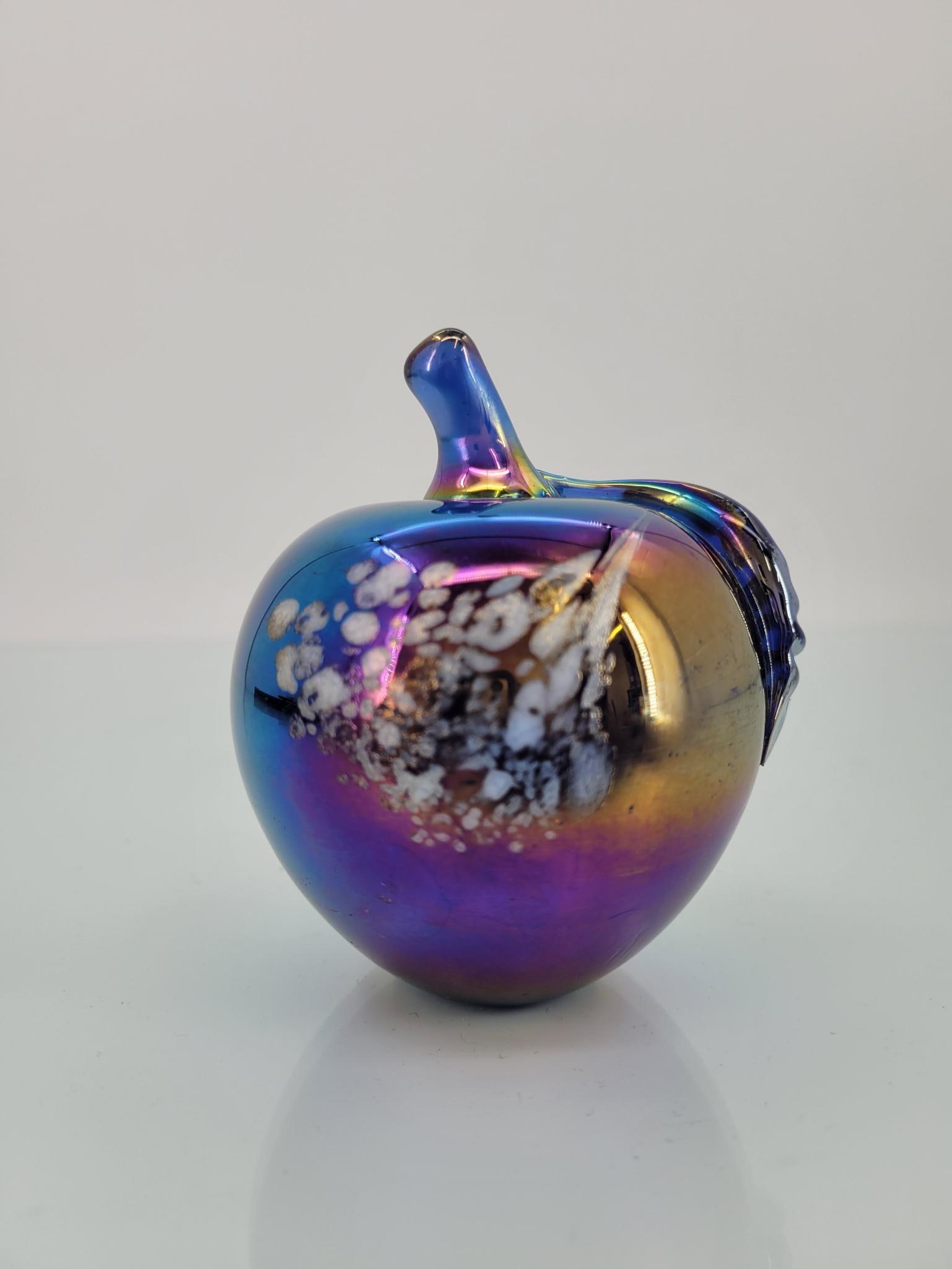 Vintage Iridescent Purple Apple Paperweight: Maker: unknownPattern: Iridescent purple apple paperweight Condition Issues (If Any): Has the remains of a makers sticker on the bottomMeasurements: 3 "L x 3.5 "H Condition Buyers P