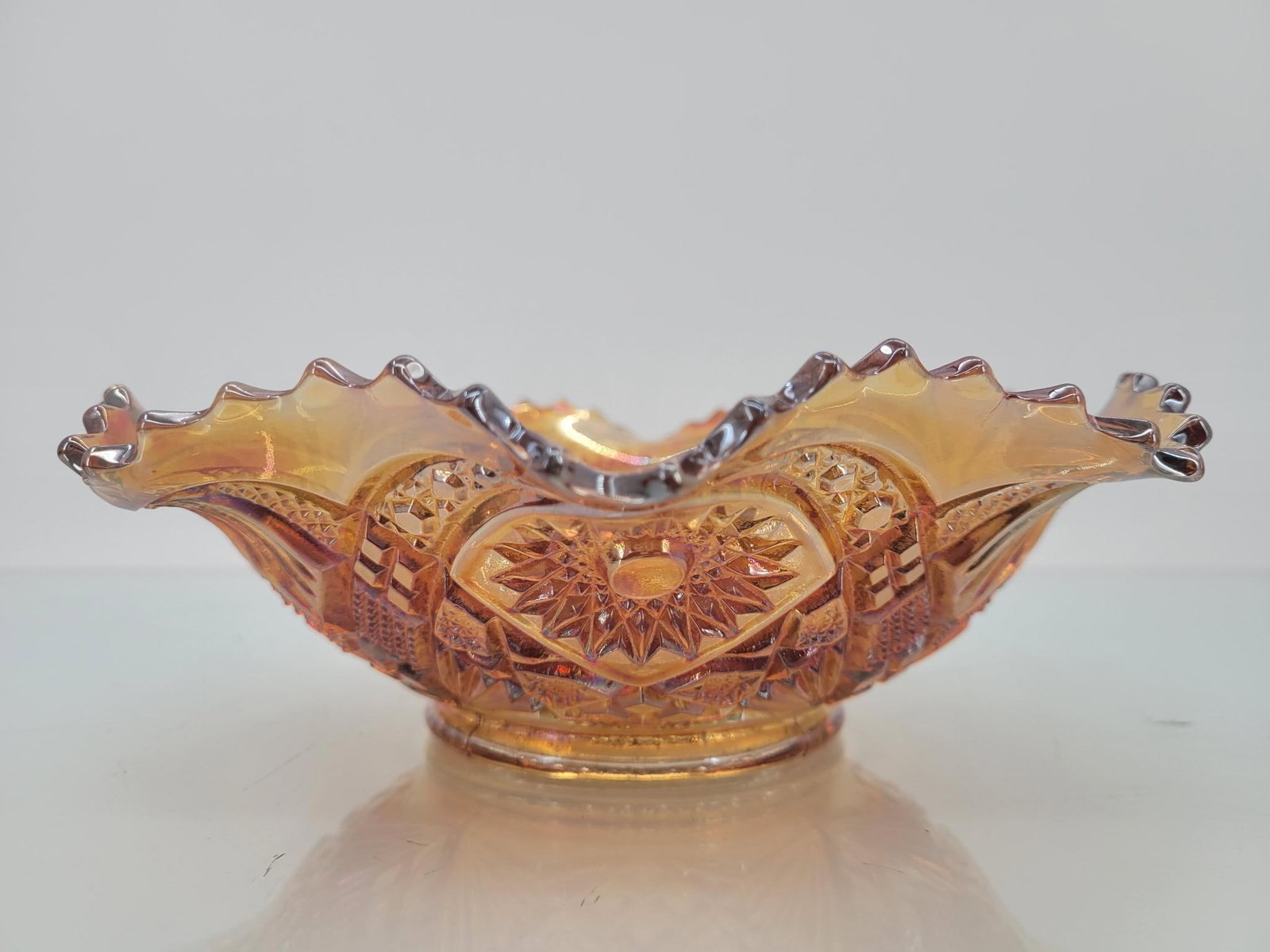 Imperial Marigold Hobstar Saw-toothed Ruffle Bowl: Maker: Imperial Pattern: Marigold hobstar saw-toothed ruffled bowl Condition Issues (If Any): none Measurements: 9 "L x 8.5 "W x 3 "H Condition Buyers Premium: 28% For t