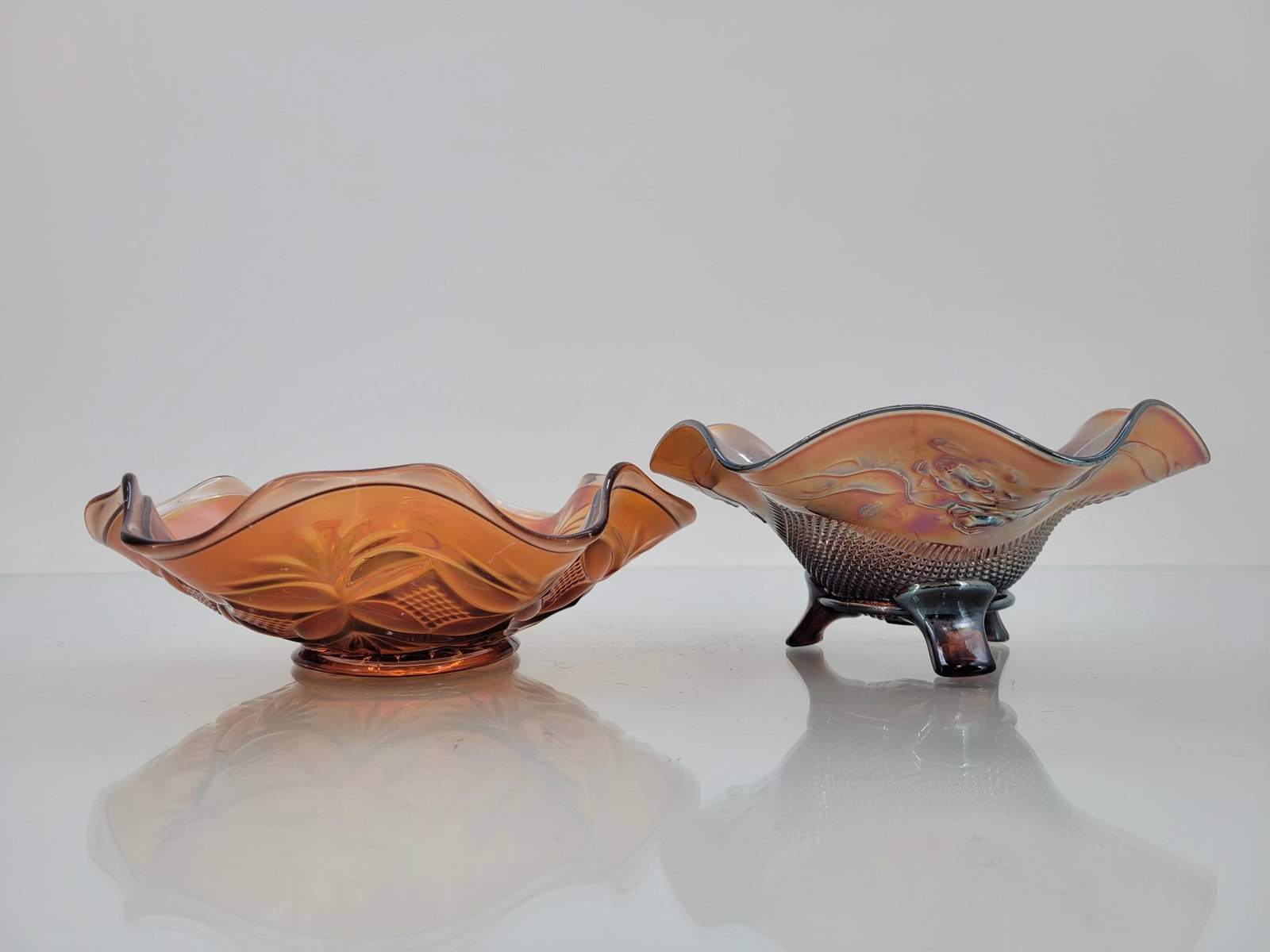 Pair of Small Purple Ruffled Bowls: Maker: Unknown Pattern: Purple ruffled bowls, footed one with floral pattern and stippling Condition Issues (If Any): none Footed bowl measurements: 7 "L x 6 "W x 3 "H Condition B