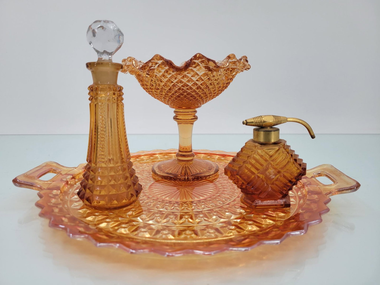 Mixed Maker Marigold Button Vanity Set: Maker: Jeanette (tray) others unknown Pattern: Marigold holiday button handled tray, pair of perfume bottles (one stamped "made in USA") , and ruffled pedestal trinket bowl Condition Issues (If Any): 
