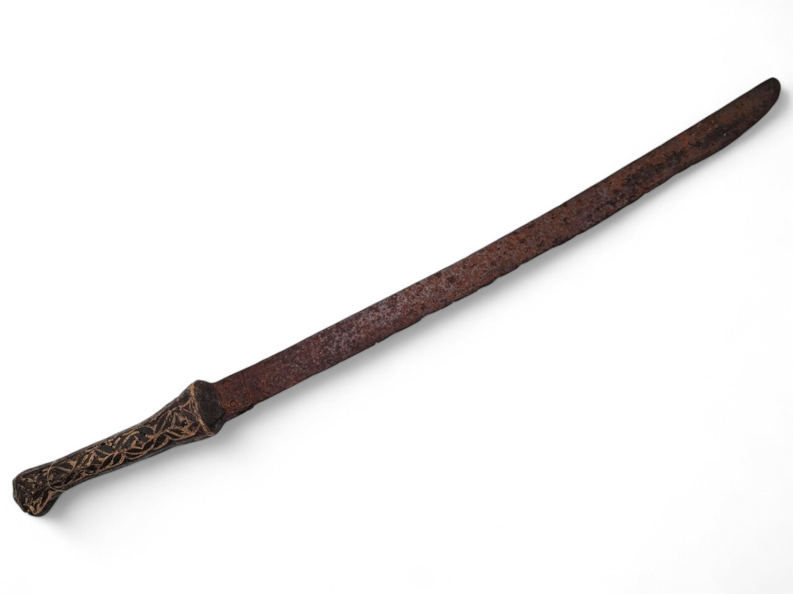 Antique Iron Sword with Decorative Handle: A rustic iron sword featuring an intricately etched handle, showcasing geometric designs. Likely handcrafted, the blade exhibits significant oxidation and surface wear, consistent with age. Exact age 
