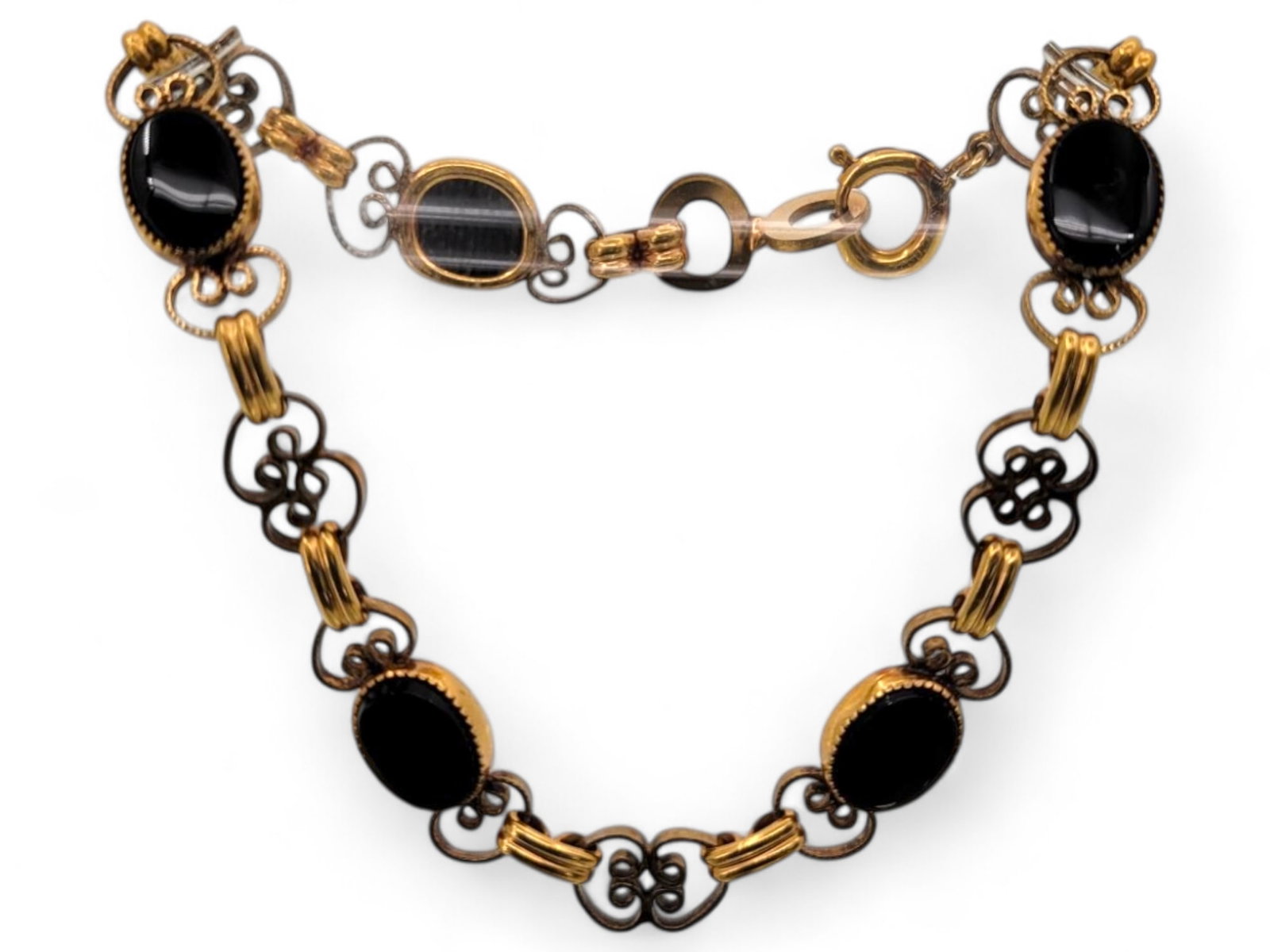 Vintage Black Onyx and Gold Filled Necklace: A striking vintage 12K gold filled necklace featuring black onyx cabochons set in gold-tone metal with decorative links. The necklace is in excellent condition with minimal signs of wear. Weight: 5.6 