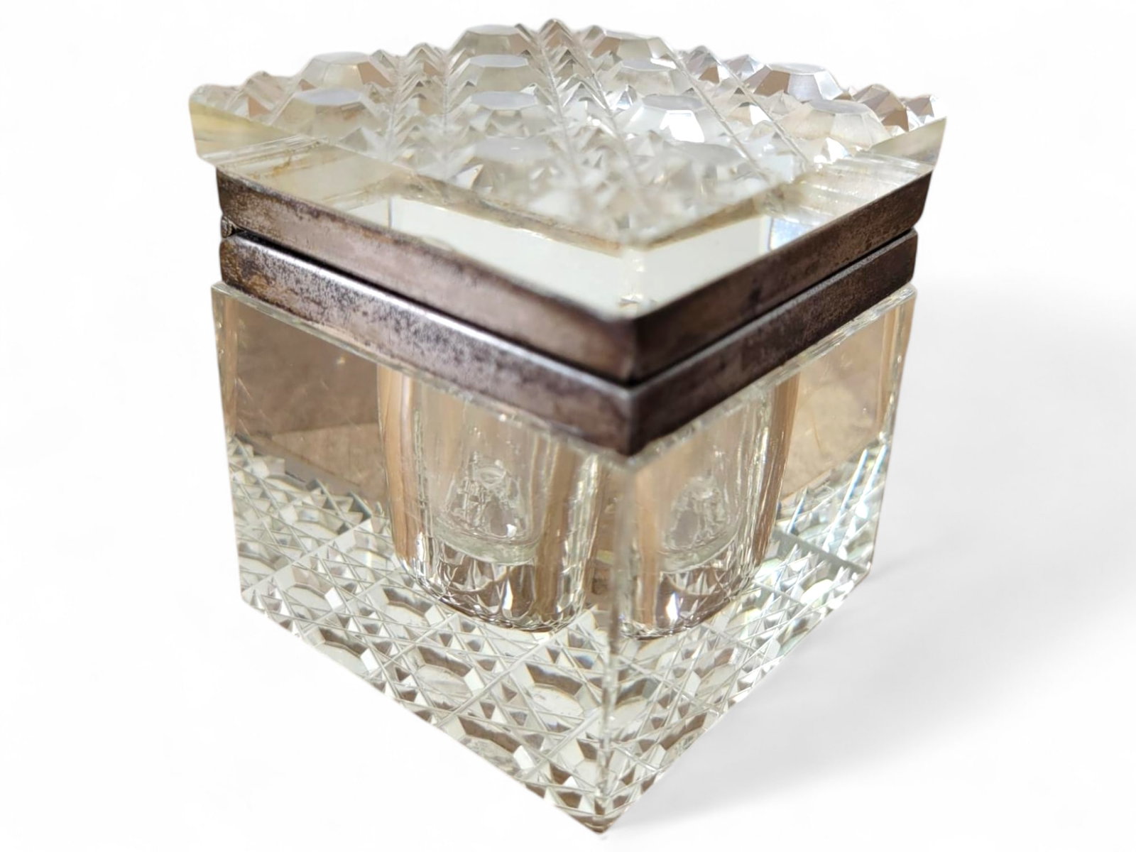 Antique Square Cut Glass Inkwell: This square inkwell showcases deep cut glass detailing and a silver-tone lid. The sharp patterns on the glass contrast elegantly with the aged patina of the metal. In good antique condition. Refer to 