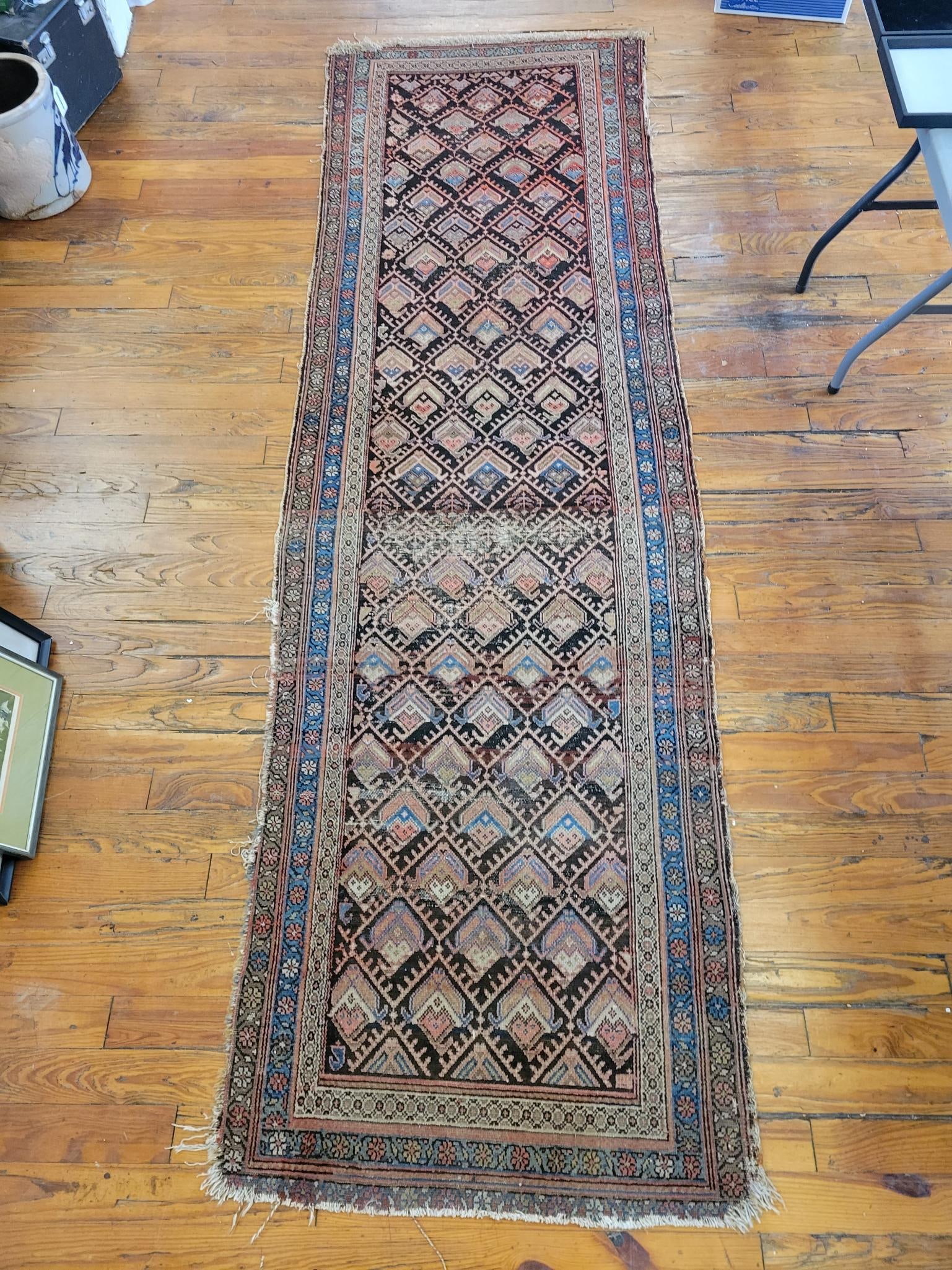 Antique Hand Knotted Long Rug - X" x X": This lot includes an antique hand knotted long rug, the rug itself is bright and shows minimal color fading with some areas of visible ware. See photos for more detail on the lots condition and 
