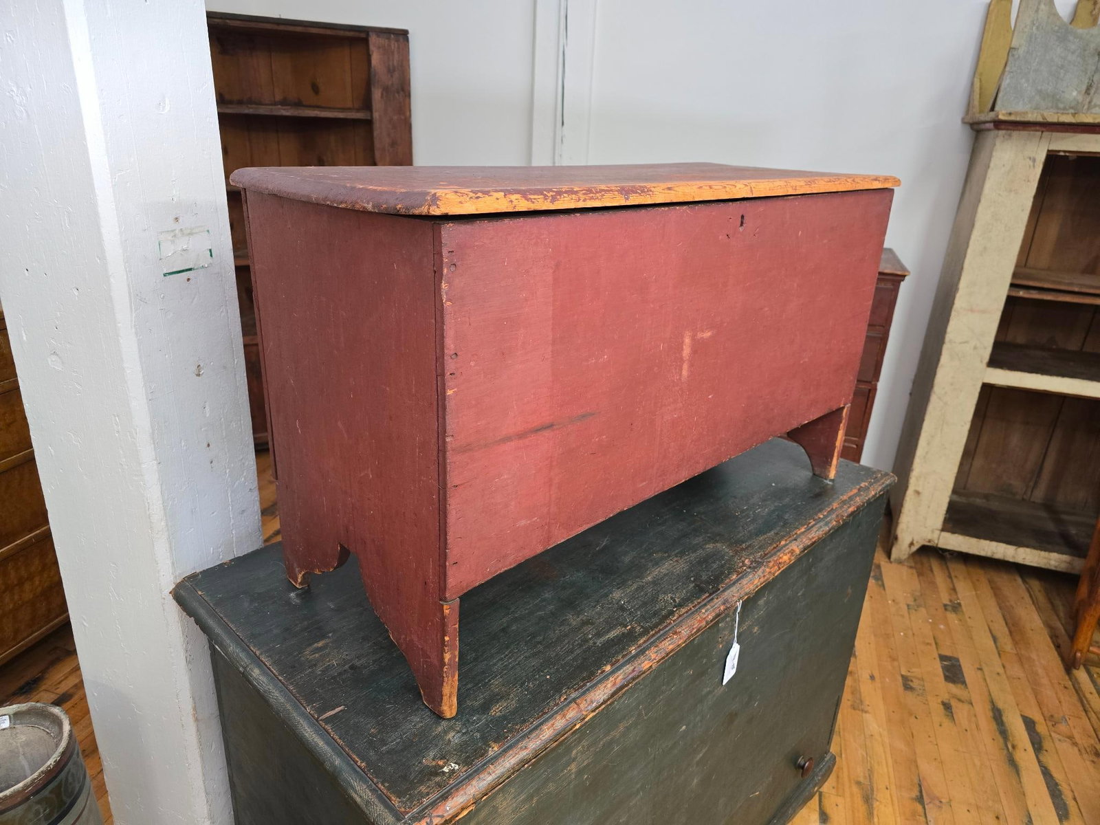 Early American Red Painted Whale Tail Blanket Chest: This lot includes a wonderful early American blanket chest with an aged red painting finish and scroll word whale tails on either side. The piece is antique in age, appearing to date to the late