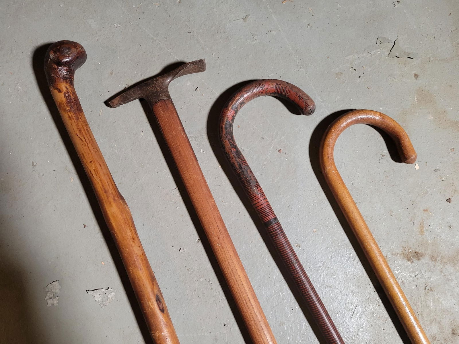 Grouping of Antique Canes & Walking Sticks - Estate Found!: This lot includes a small grouping of estate found walking sticks / canes. There are 4 pieces in total, with conditions types and ages varying. Condition all appear good, the tip of the metal end on t