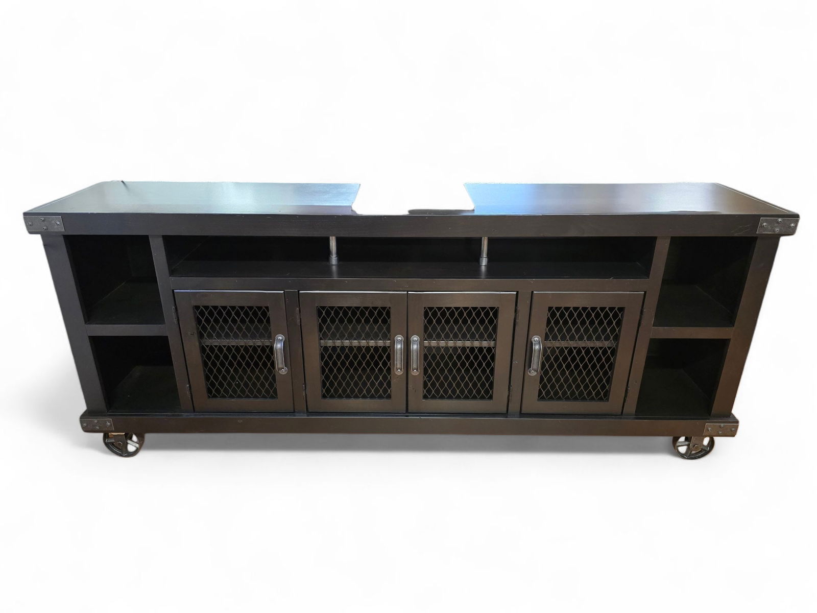 Jordans Furniture Industrial 4 Door 84" Console with Casters - $1,800 New: The console table was purchased new from Jordans Furniture in Nov. of 2022, and remains in like new condition from a very well kept home. Finished in Ghost Black with an industrial look. The table is