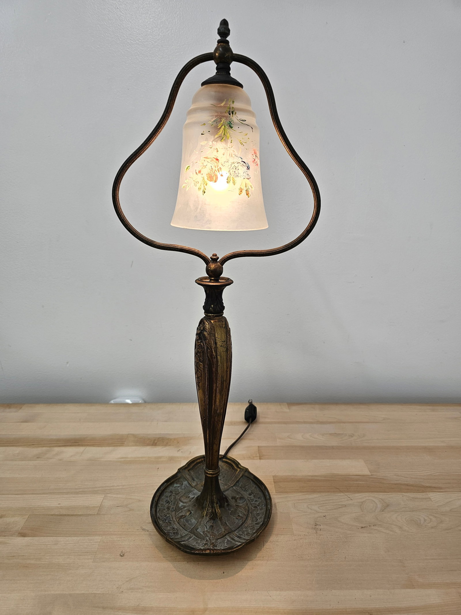 Antique Art Nouveau Gilt Brass Harp Table Lamp: The lamp has a distinctive Art Nouveau style, with a gilt brass base featuring floral designs throughout. Much of the original gilt finish is missing, though some areas remain visible. The single harp