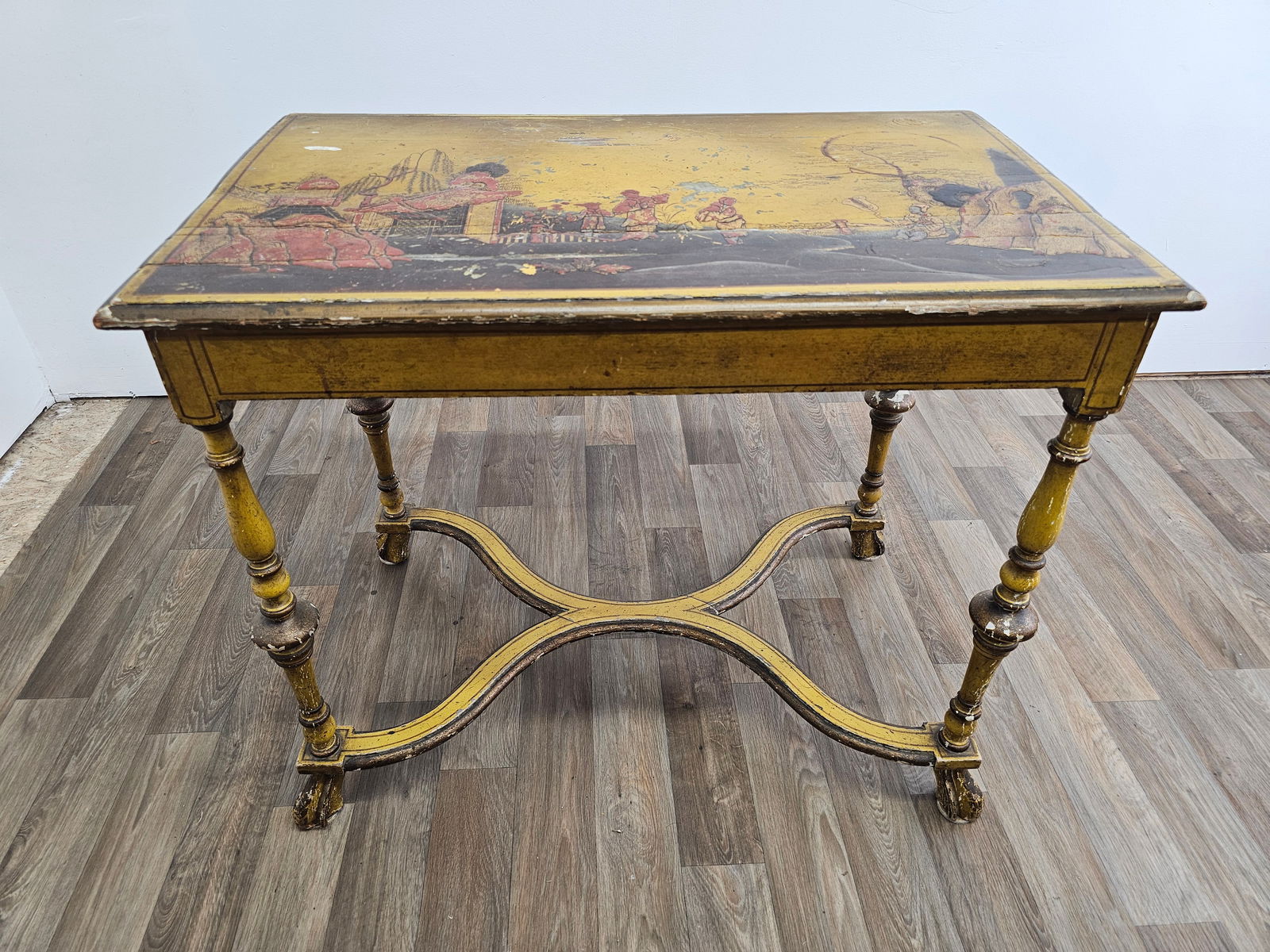 Antique Provincial Style Chinese Lacquered Accent Table: The table features a yellow painted finish with Chinese scenes to the top. The piece is antique in age, and beautifully worn from age and use showing some losses and paint chips throughout. See lot ph