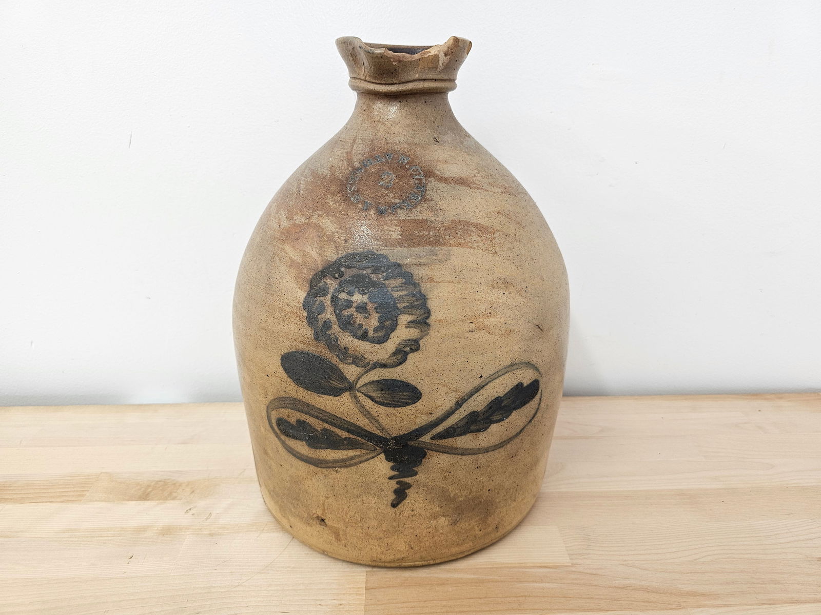N. Clark, Jr., Athens, N.Y. Stoneware Jug - Cobalt Painted Flower: The 2-gallon jug is marked on the front "N. Clark, Jr., Athens, N.Y." and features a cobalt-painted flower design on the front. Unfortunately, there is a large chip to the spout, but otherwise, the ju