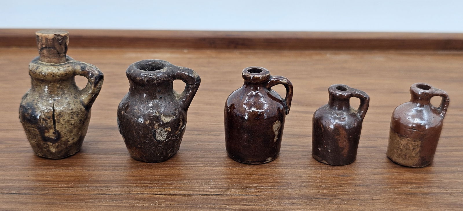 Lot of American Clay Terracotta Miniature Jugs - 1.5"T: This lot includes a grouping of very small miniature terracotta jugs, each standing only 1.5" tall. The pieces retain there original finish with no major damage or flaws beyond some expected age chips