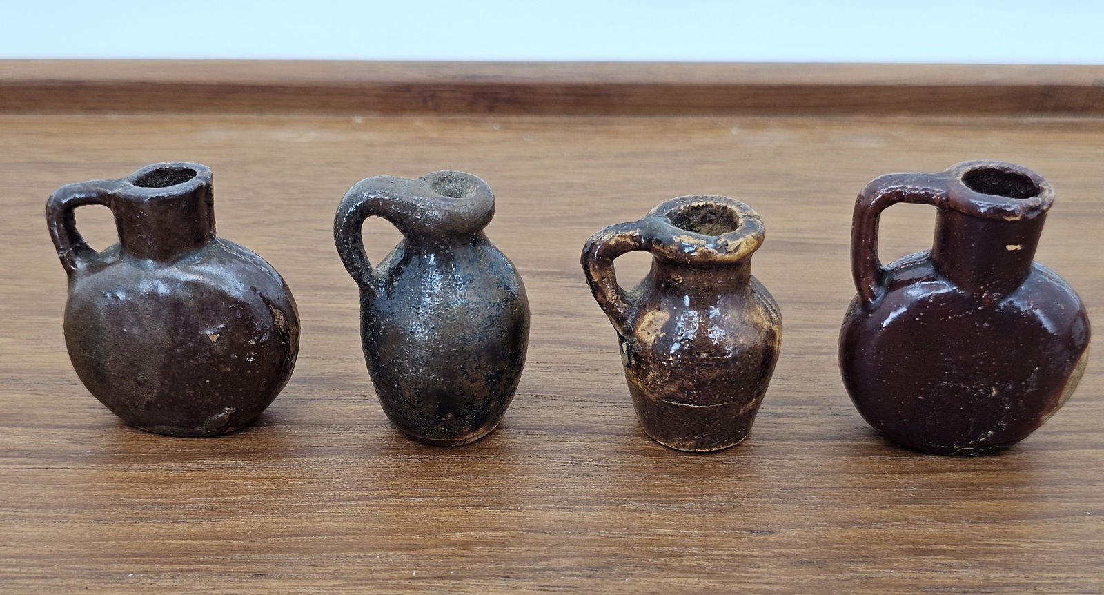 Lot of 19th Century American Clay Terracotta Miniature Bottles - 1.75"T: This lot includes a grouping of very small miniature terracotta bottles, each standing only 1.75" tall. The pieces retain there original finish with no major damage or flaws beyond some expected age c