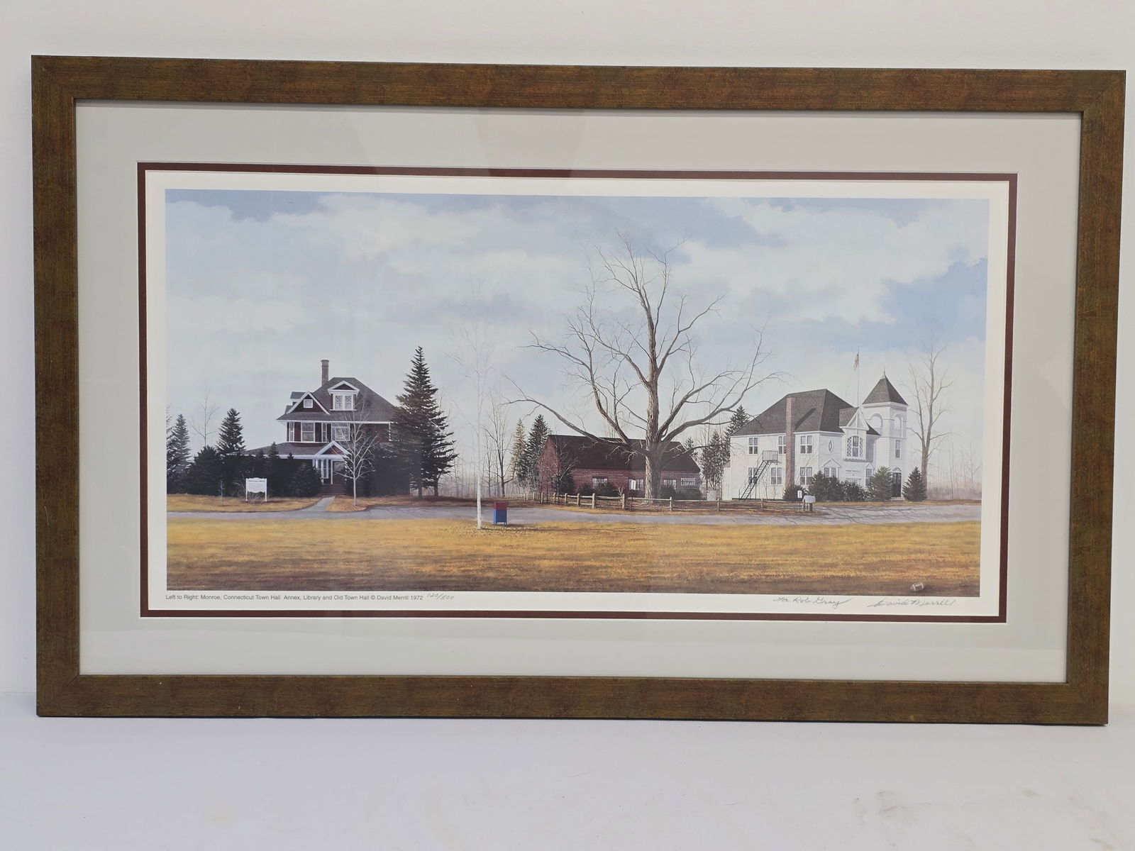Signed Print "Monroe CT Town Hall Annex" by David Merrill 1972: The signed and numbered print is titled "Monroe, Connecticut Town Hall Annex, Library and old Town Hall" by David Merrill 1972. The framed artwork is pencil signed and numbered (120/500) on the bottom