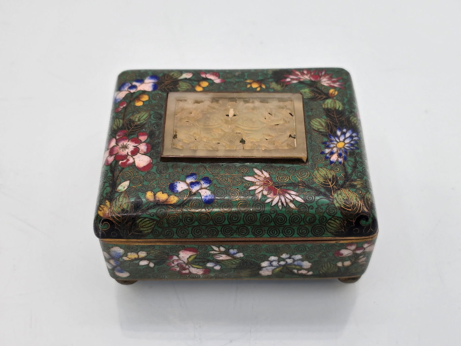 Vintage Chinese Cloisonne & Jade Trinket Box: The box is in very good vintage condition, featuring a carved jade medallion at the center of the lid. The piece shows no visible damage. See lot photos for more details and lot information. Measures