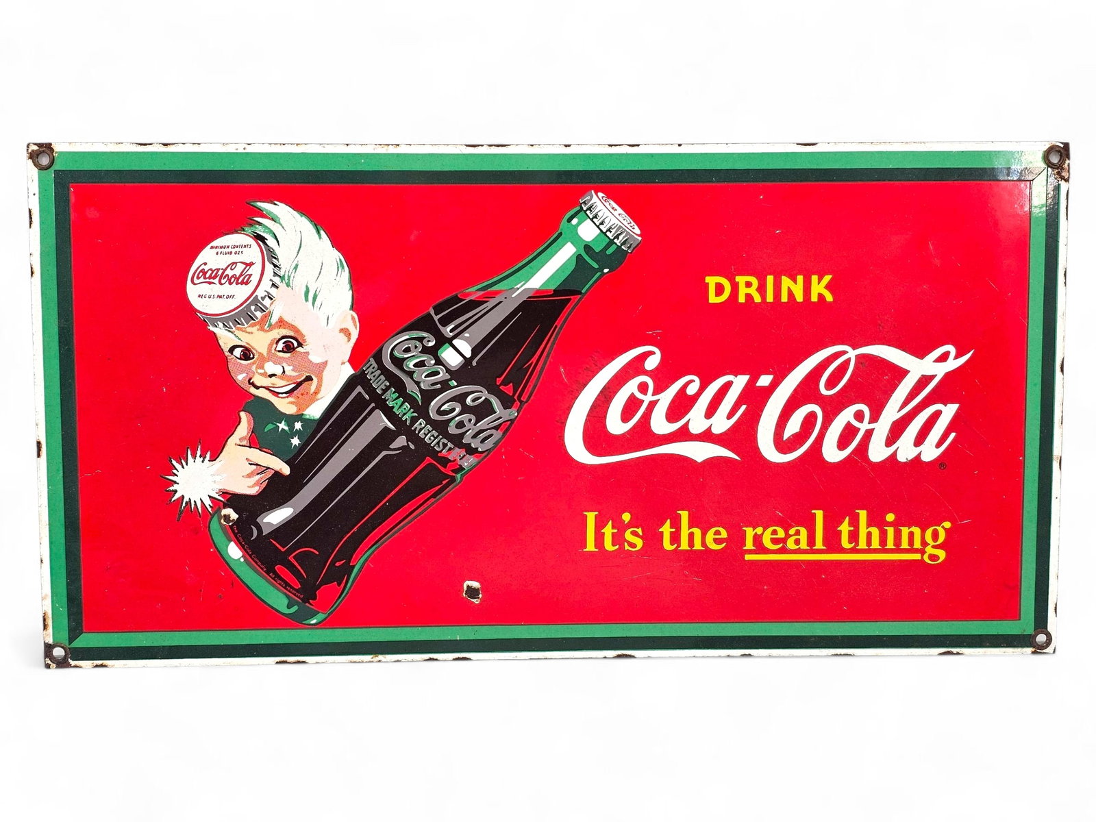 Vintage Coca-Cola "It's the real thing" Sprite Boy Porcelain Wall Sign: The sign is in good vintage condition, showing very minor chips to the edges as expected with age and use. The sign is still bright and vibrant with a glassy finish. The sign itself looks to be vintag