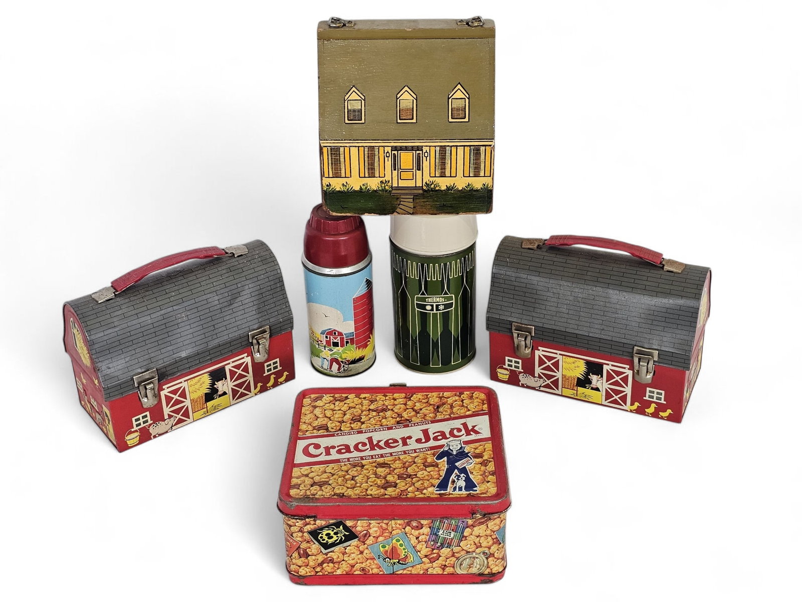 Grouping of Vintage Tin Lithograph Lunchboxes: This lot includes a small grouping of vintage lunchboxes of various styles and ages. They all appear vintage and in good overall condition, showing some ware and scuffs as expected from age and use. S